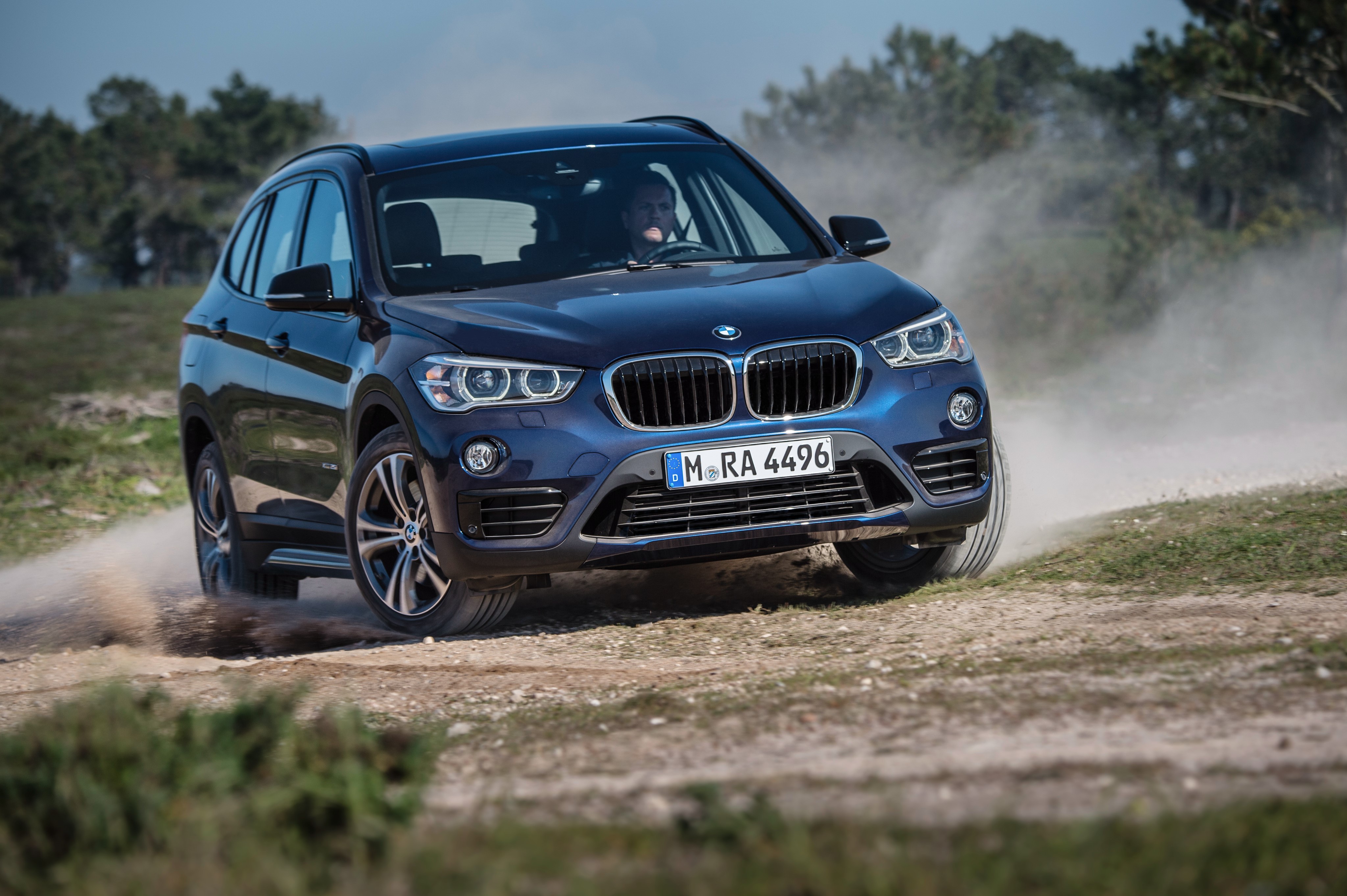 4K 2015 BMW X1 xDrive Sport Line F48 driving on dirt road HD Wallpaper