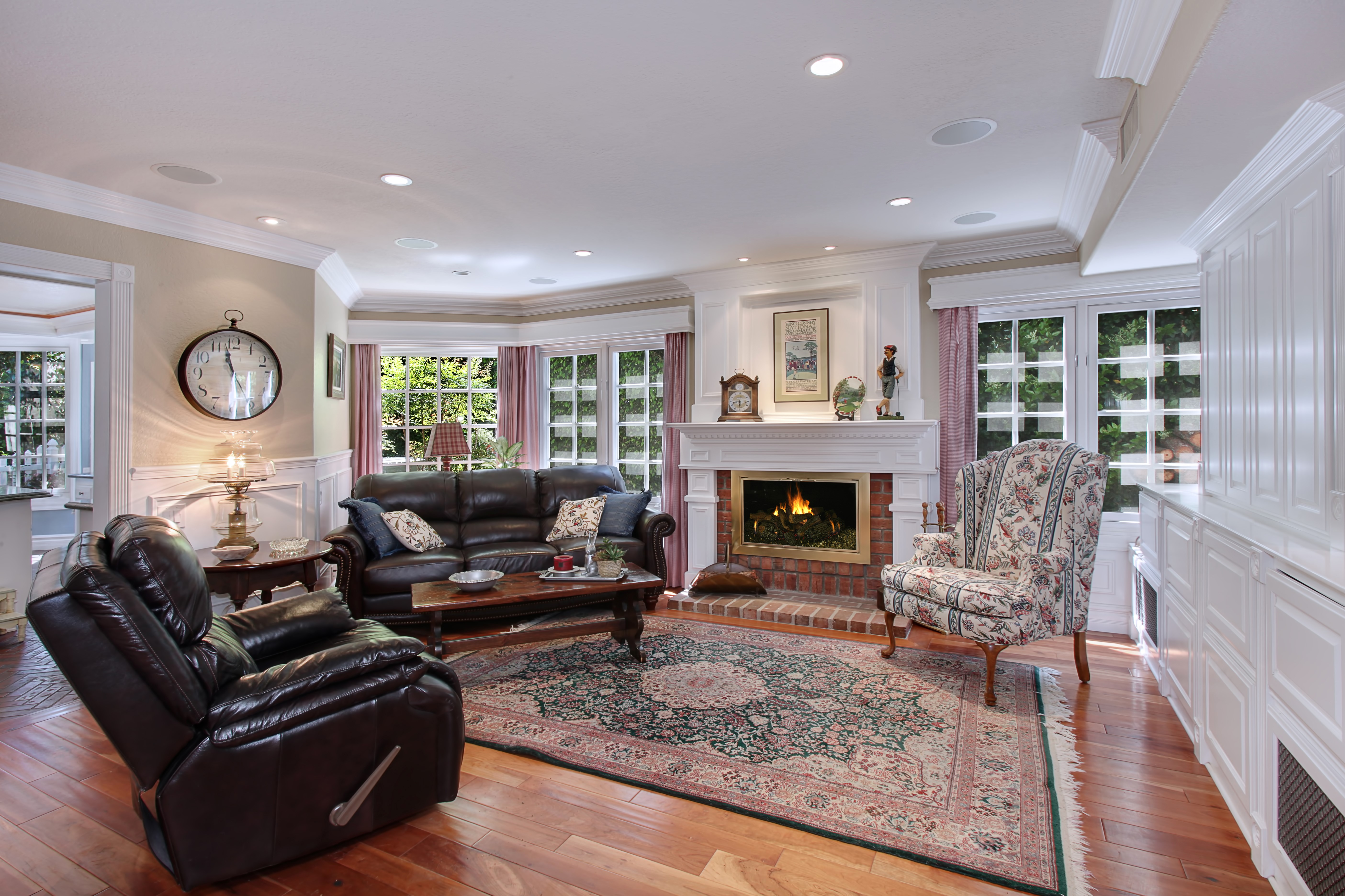 Living room with fireplace, sofa, and armchair HD Wallpaper