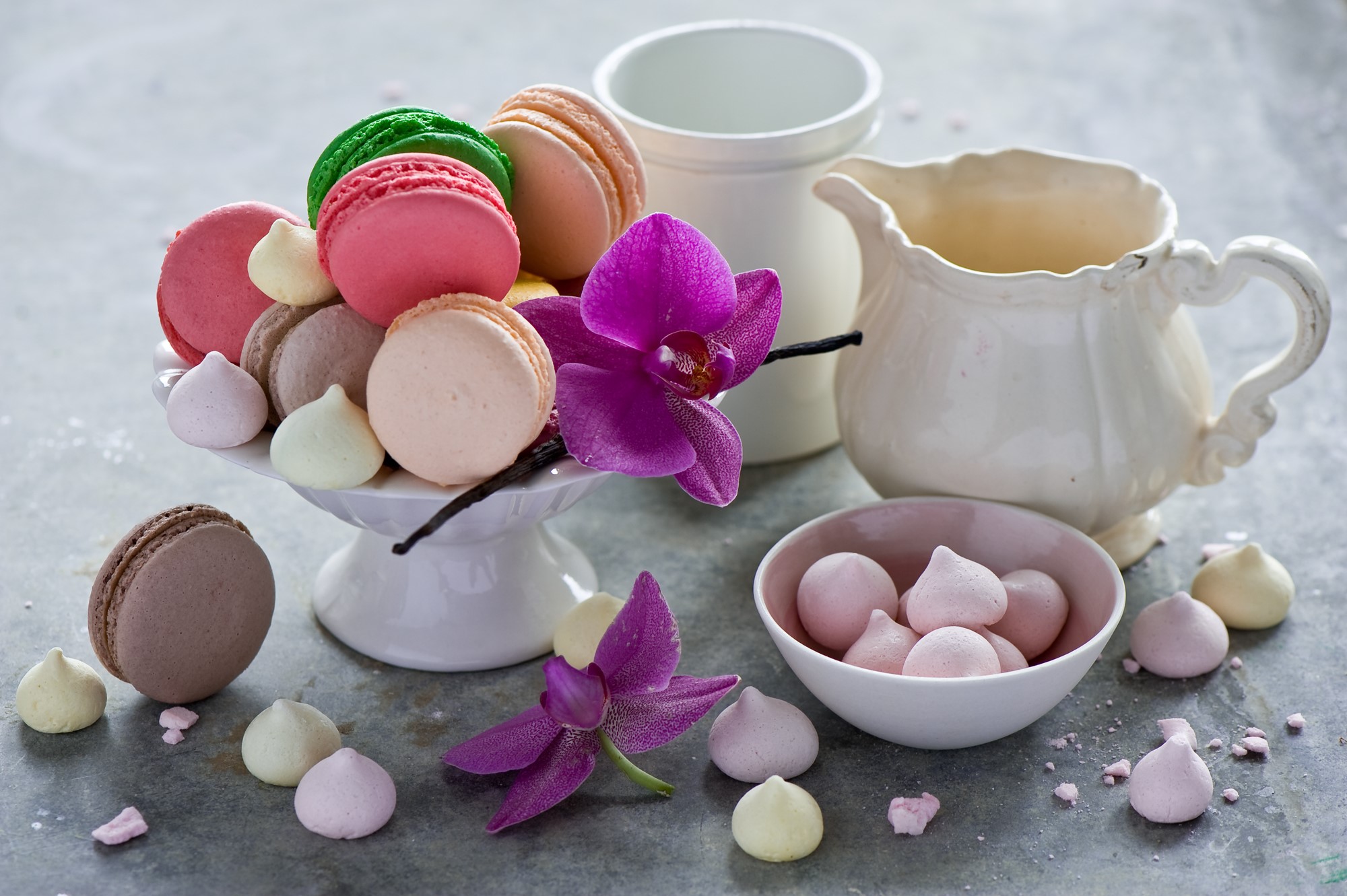 Macarons and meringues with orchids and cream pitchers HD Wallpaper