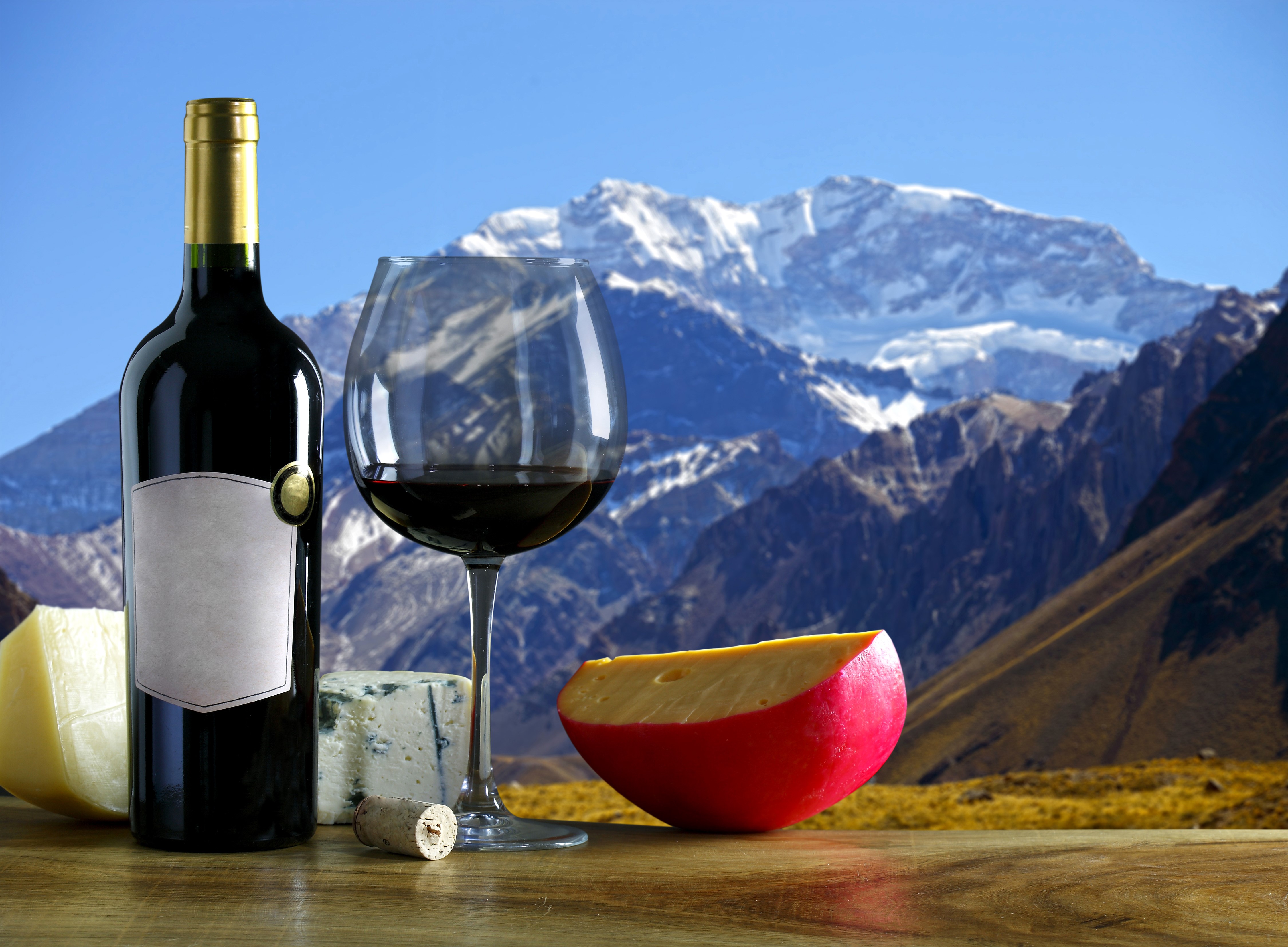 Wine bottle and glass with cheese and mountains HD Wallpaper