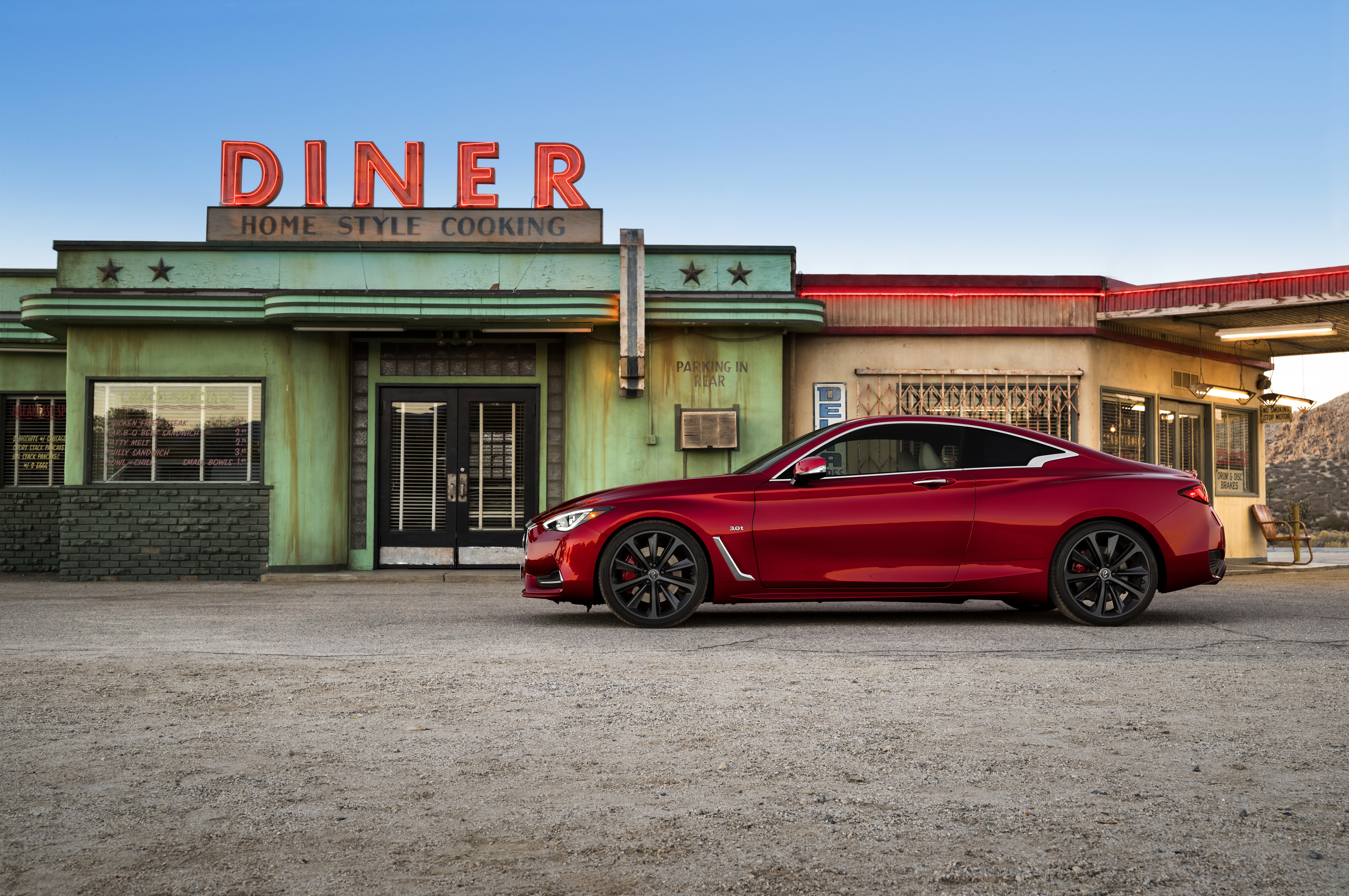 Red 2016 Infiniti Q60 Coupe parked at a retro diner HD Wallpaper