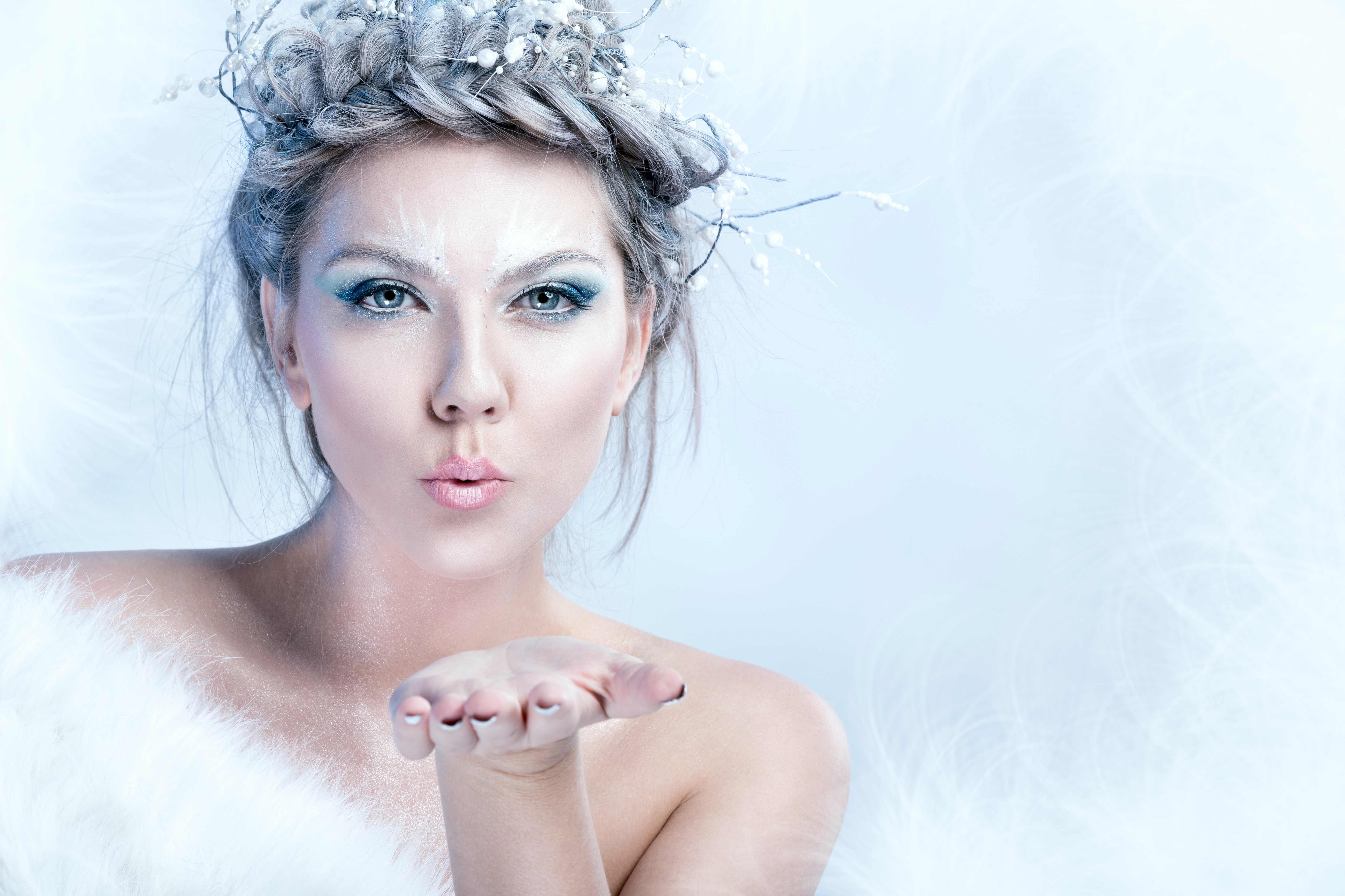 Woman with winter makeup blowing a kiss HD Wallpaper