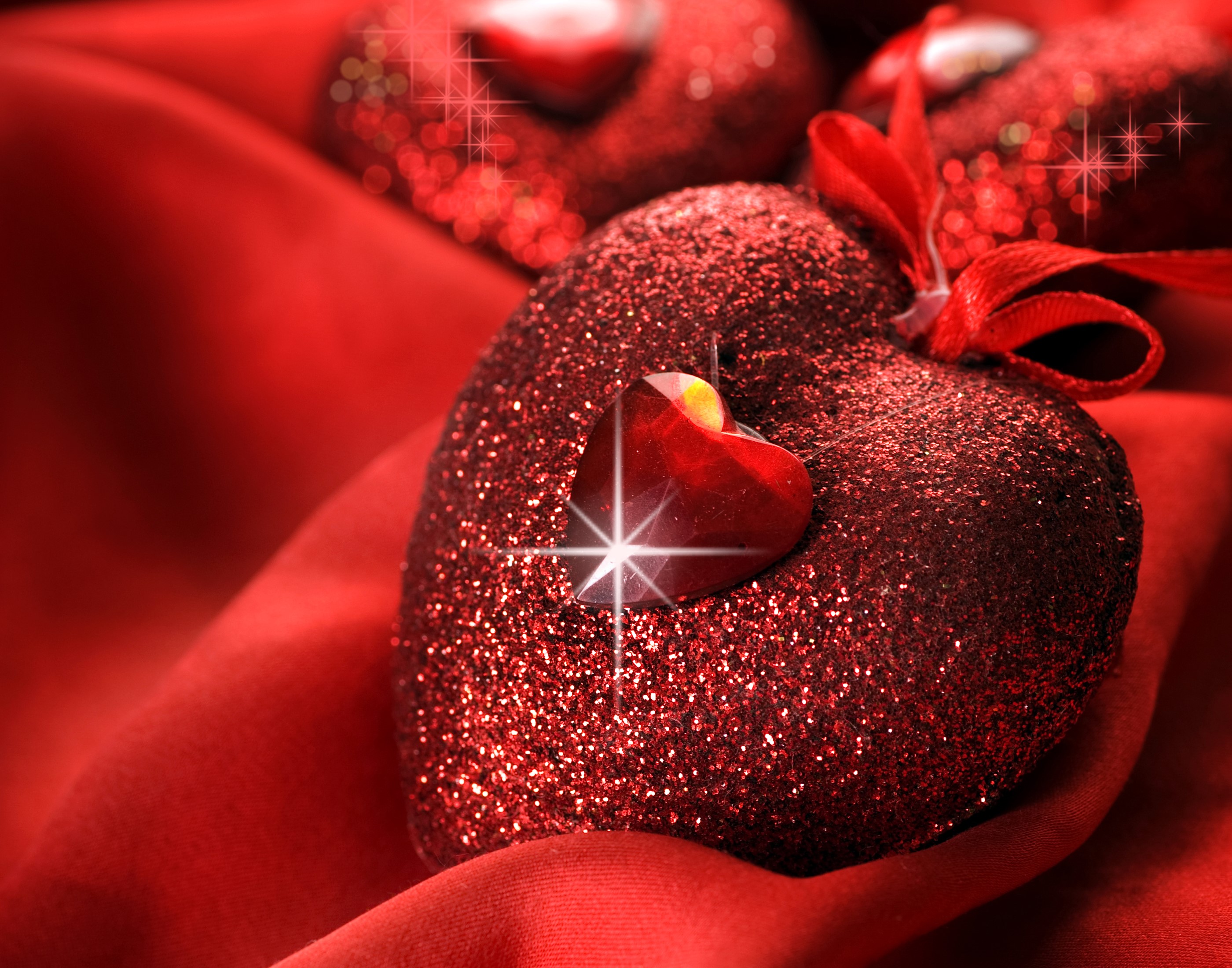 Glittering red hearts on red satin HD Wallpaper