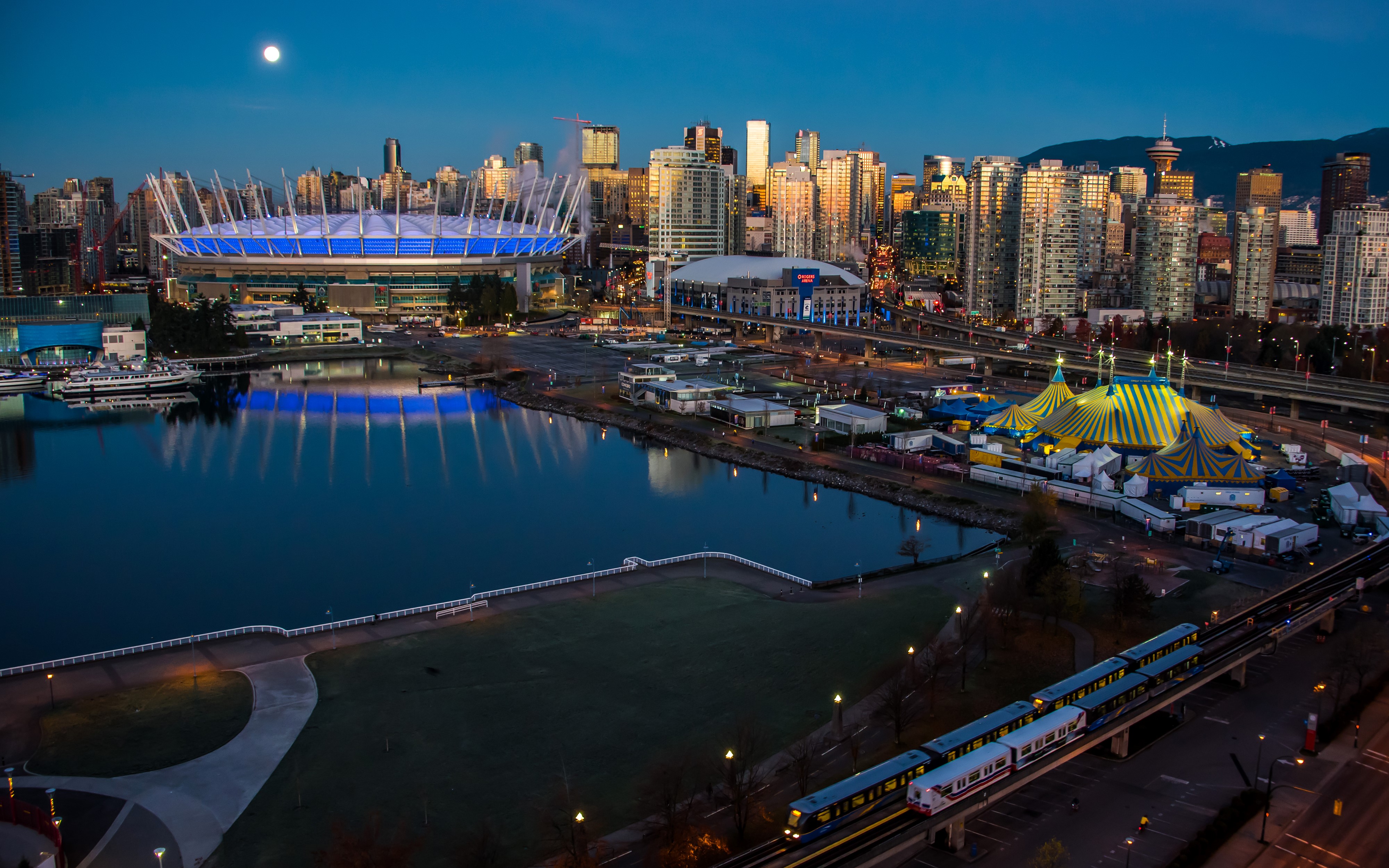 Vancouver cityscape with stadium, circus tent, and train at night HD Wallpaper