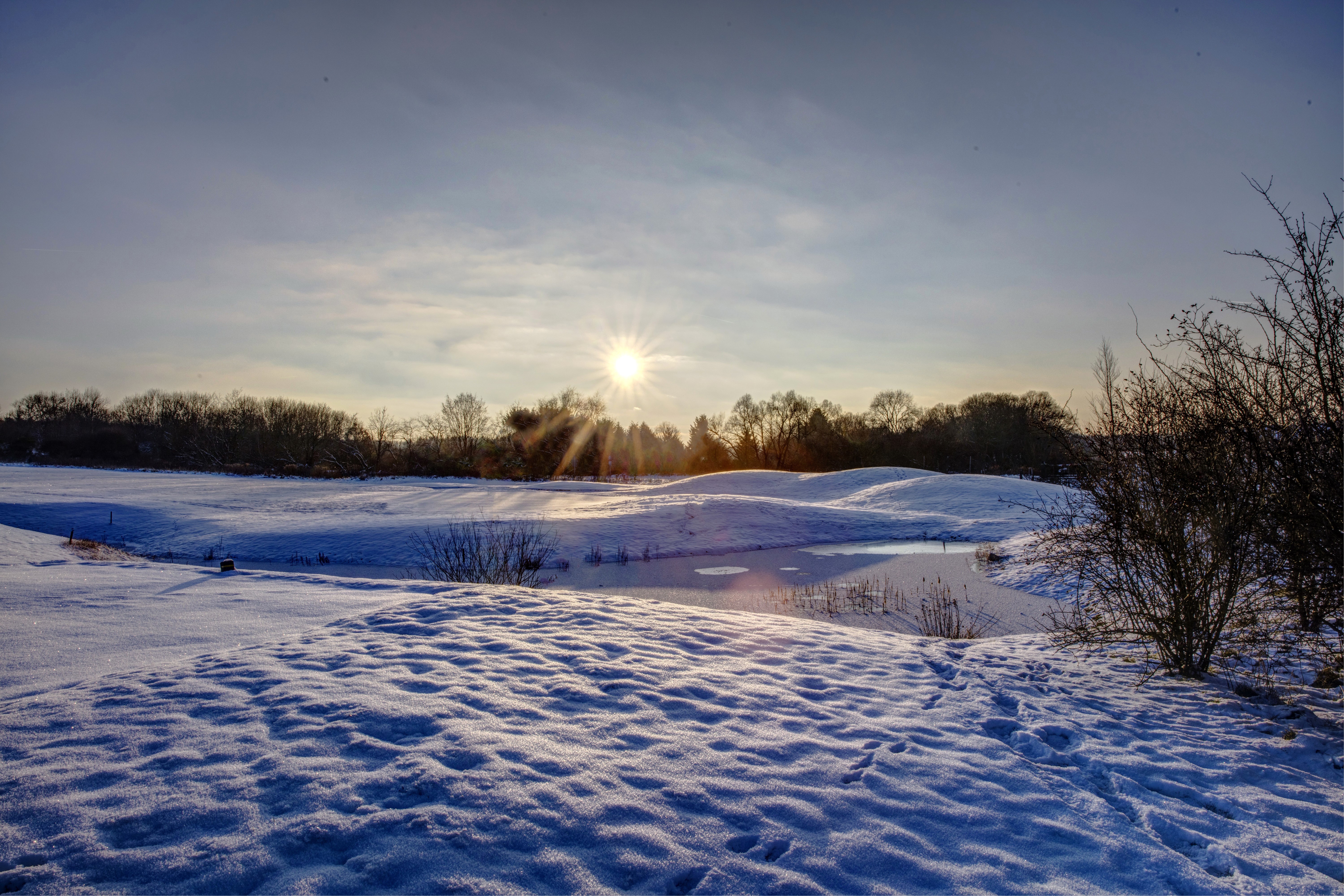 Winter landscape with sunbeams over snow and water HD Wallpaper