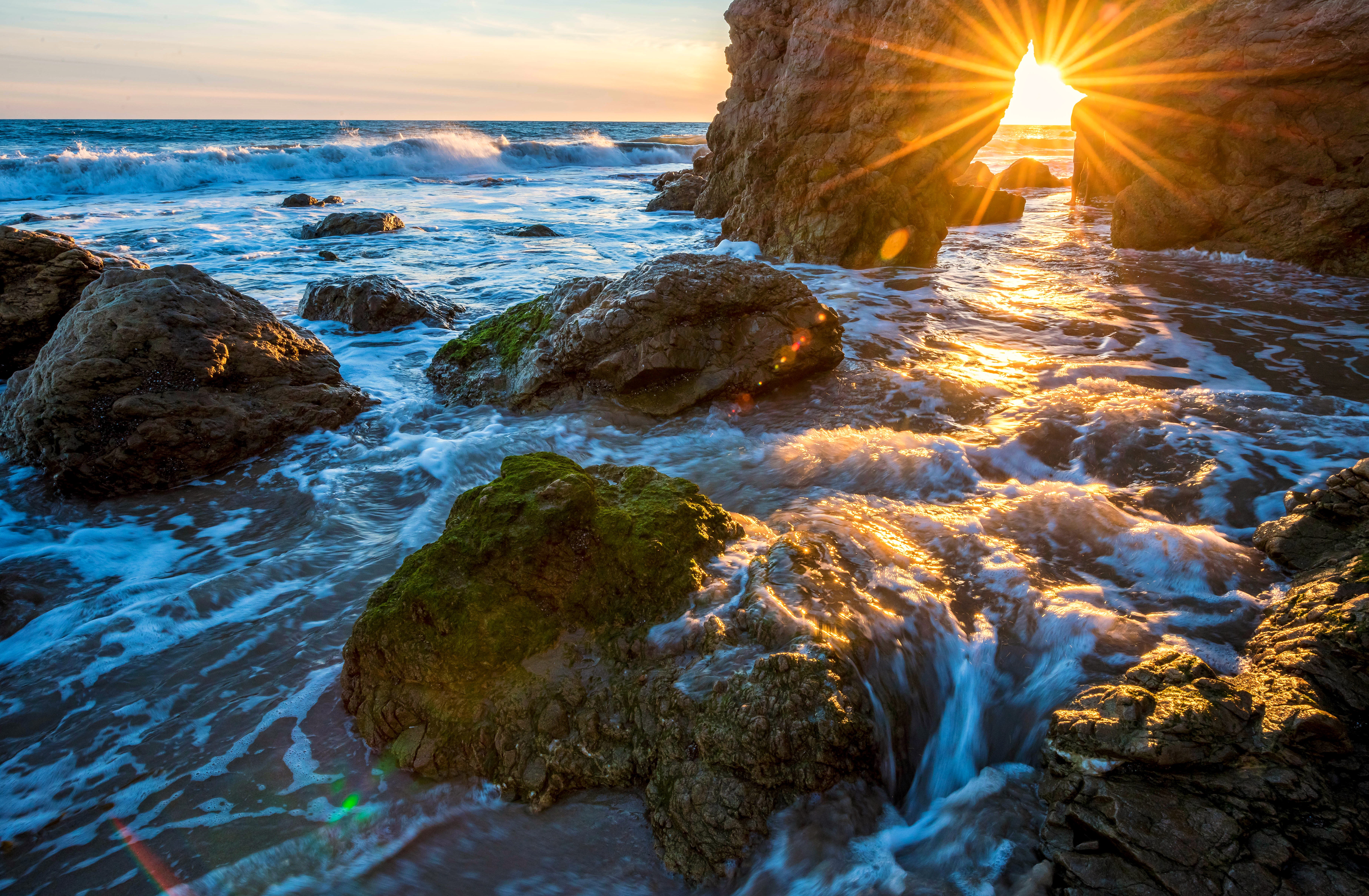 Sunset through rock arch at Malibu beach, California HD Wallpaper