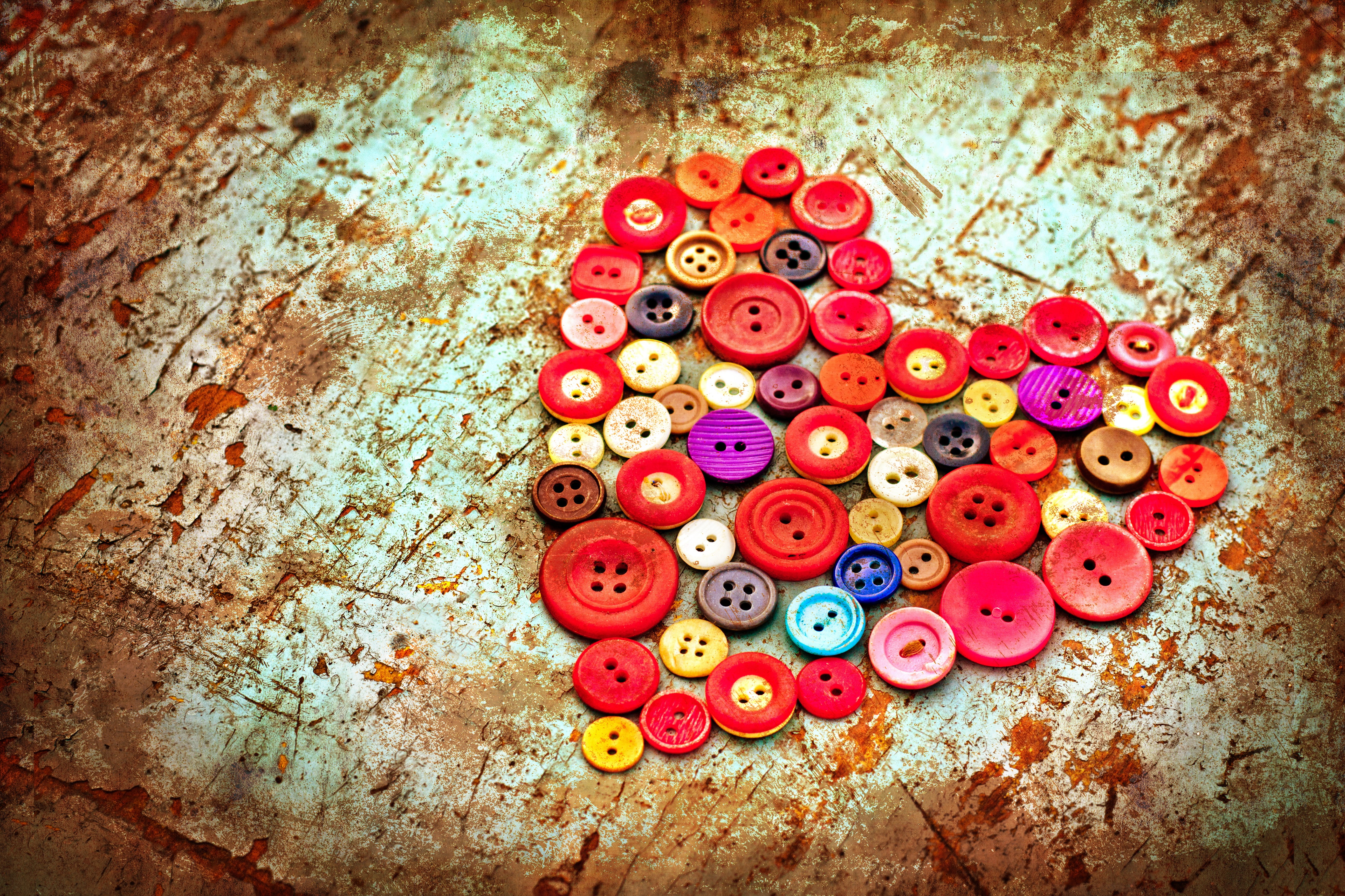 Heart shape made of colorful buttons on textured background HD Wallpaper