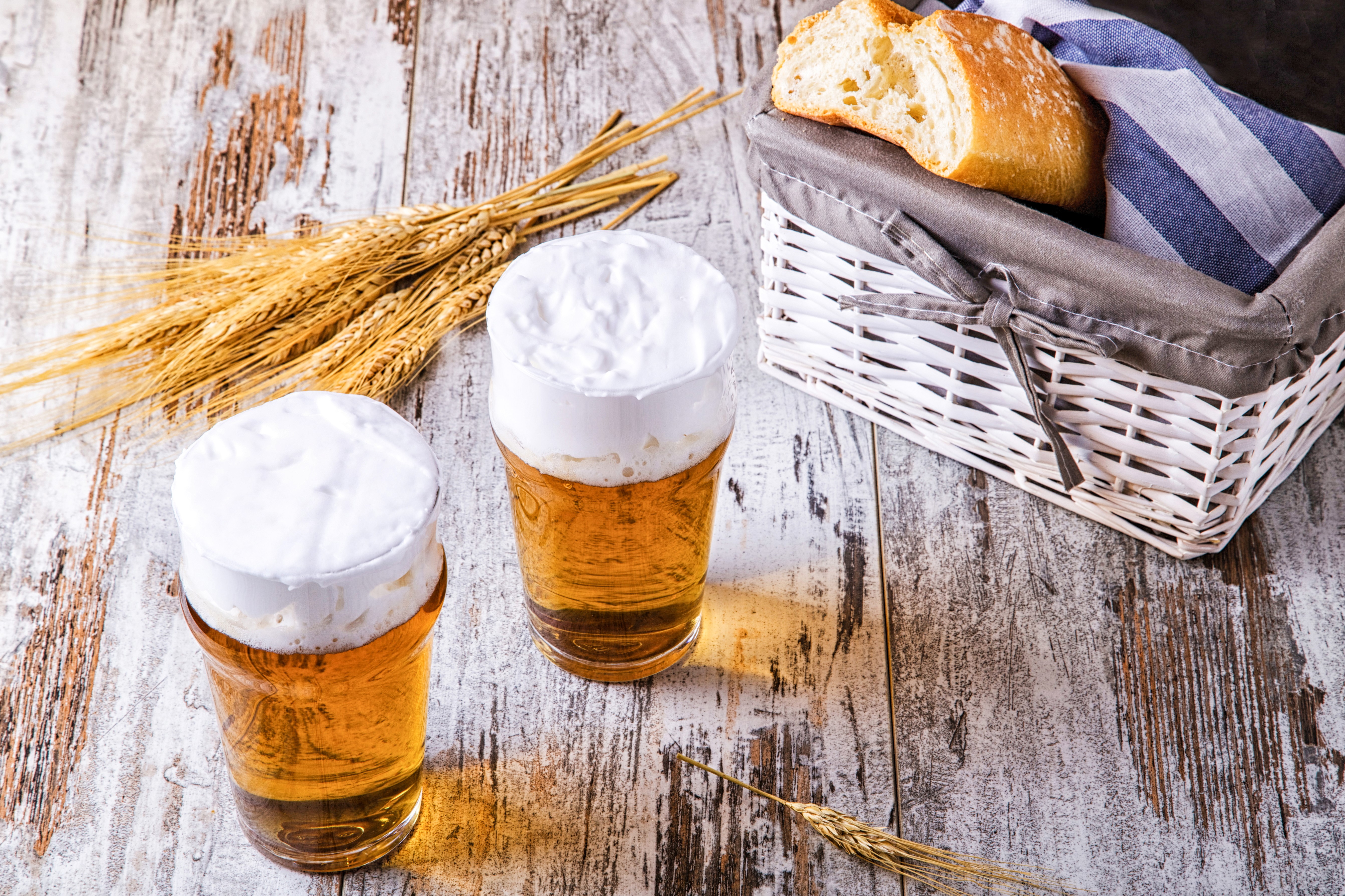 Two glasses of beer with bread in a basket and wheat HD Wallpaper
