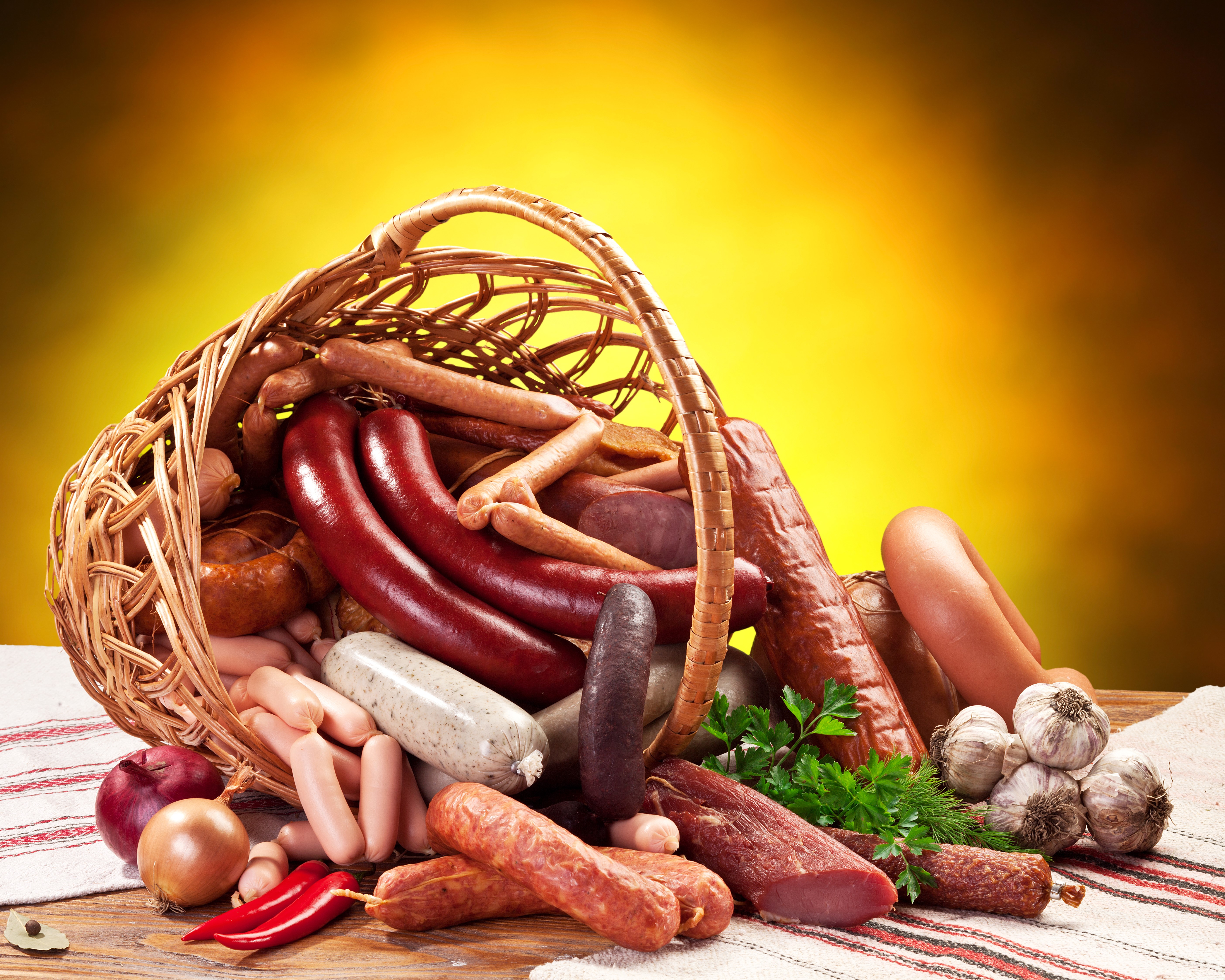 Meat products and sausages in a wicker basket with vegetables HD Wallpaper