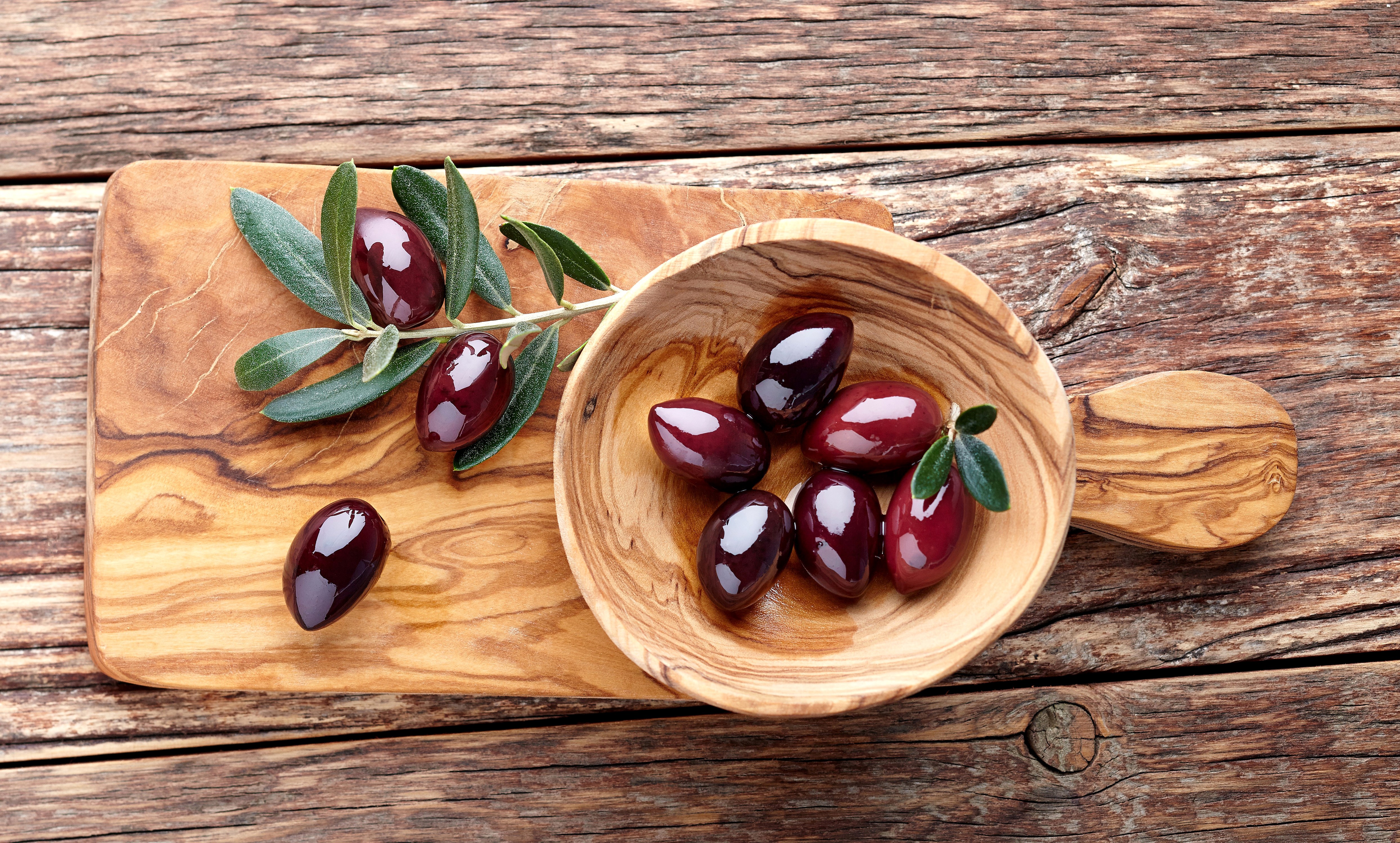 Olives on a wooden board and in a bowl HD Wallpaper