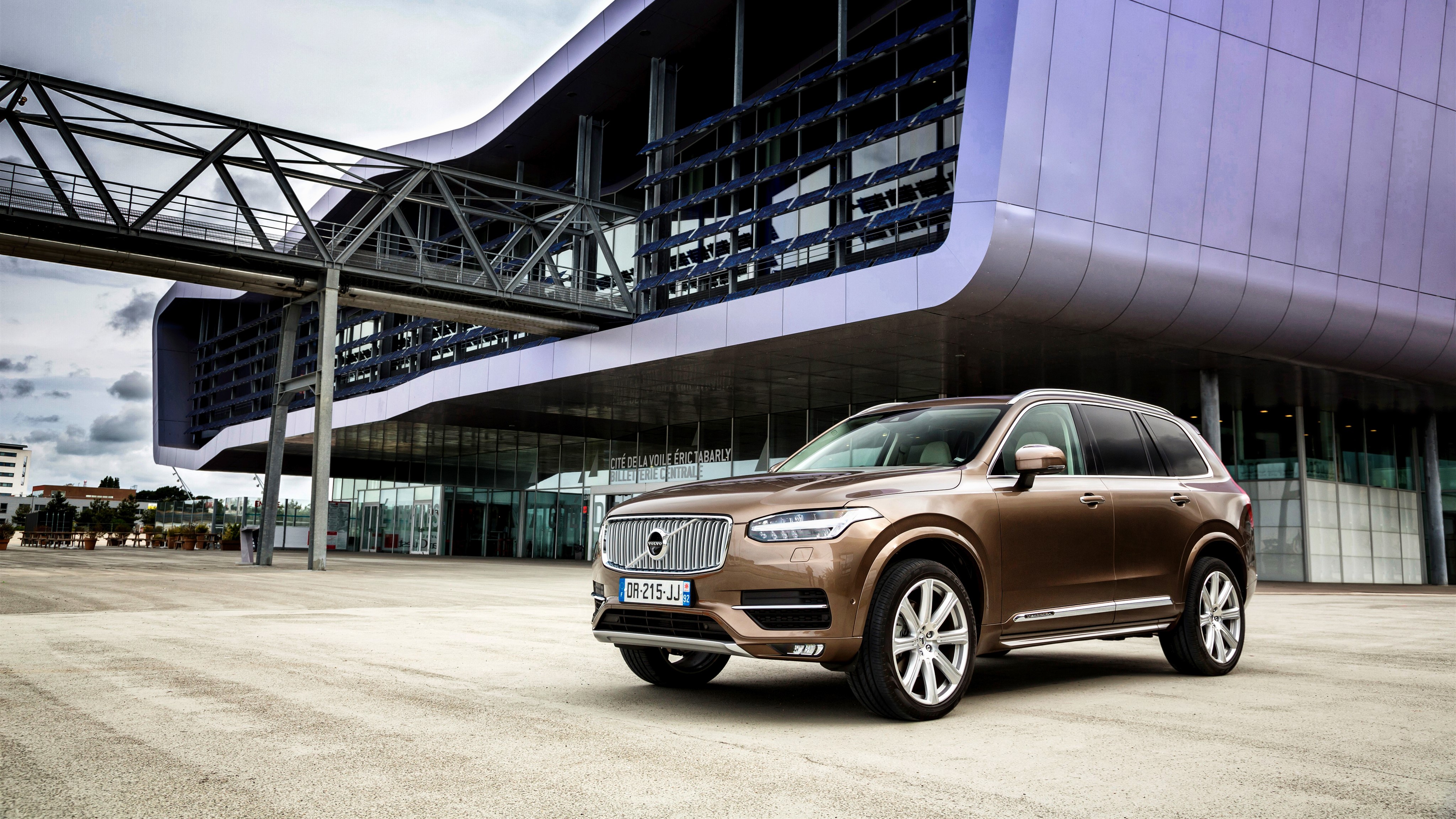 2015 Volvo XC90 D5 parked in front of a modern building HD Wallpaper