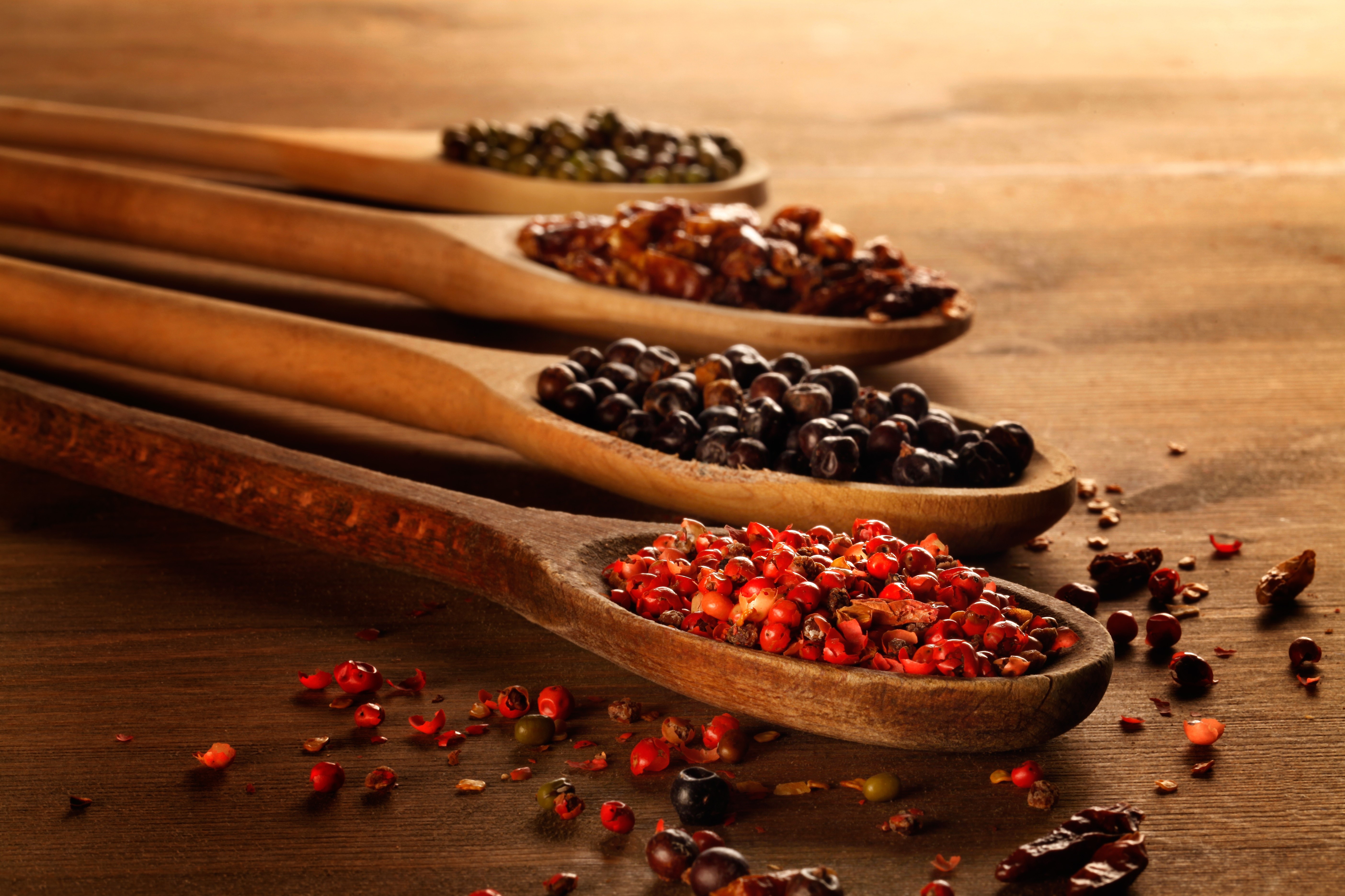 Four wooden spoons with different spices HD Wallpaper