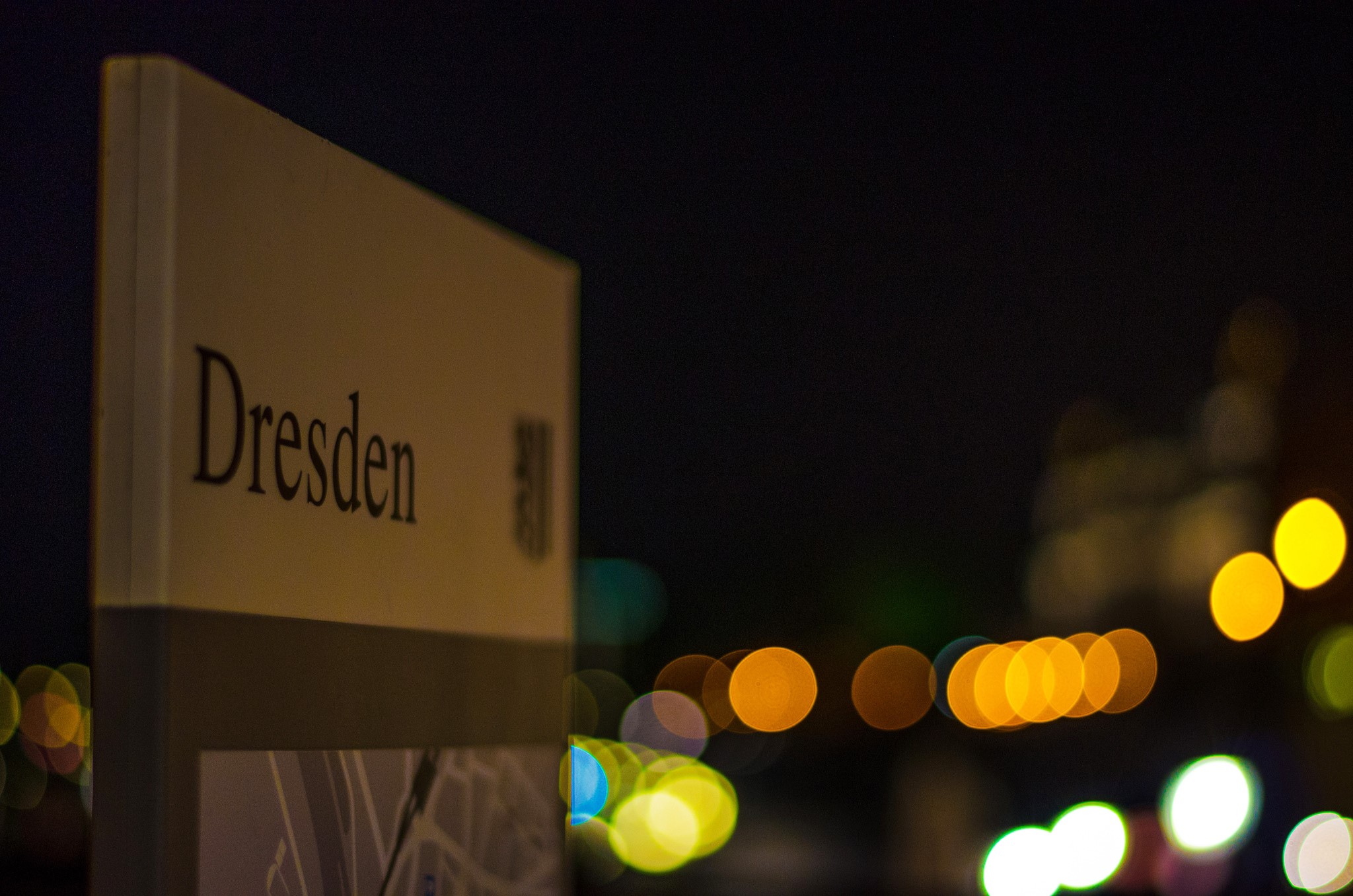 Dresden sign at night with bokeh lights HD Wallpaper