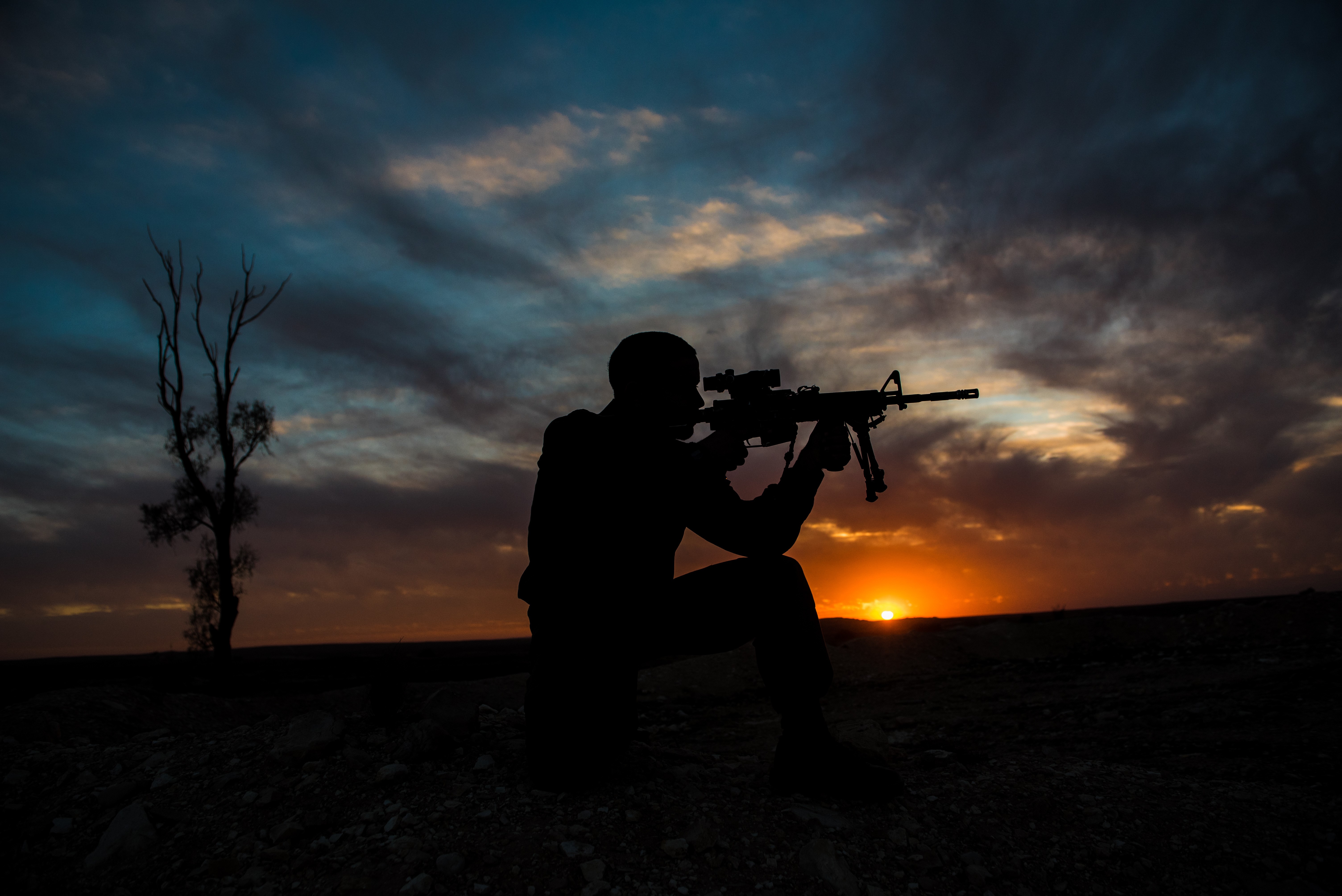 Soldier with assault rifle at sunset HD Wallpaper