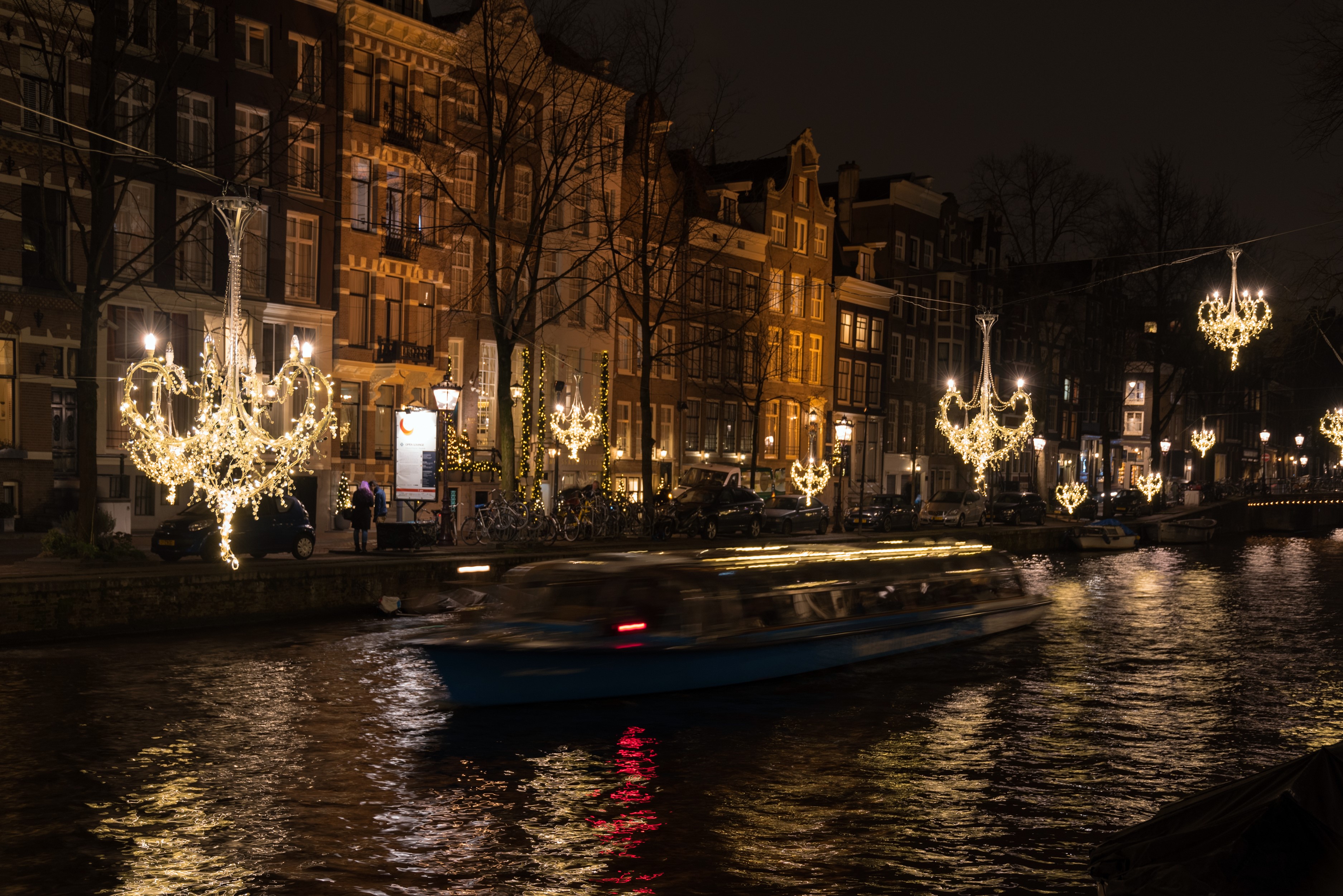 Amsterdam canal at night with boat and fairy lights HD Wallpaper