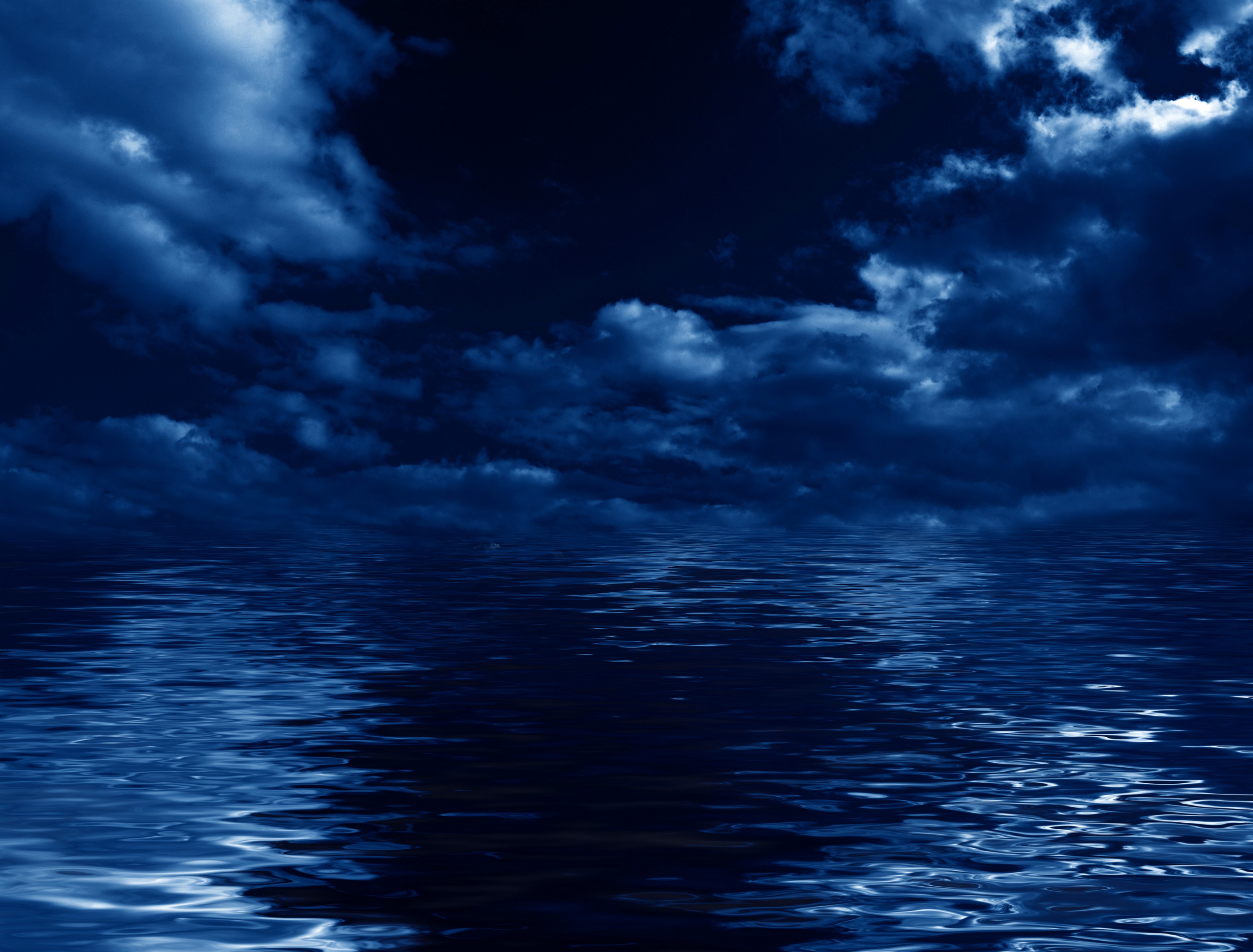 Dark Clouds Over Reflective Water at Night HD Wallpaper
