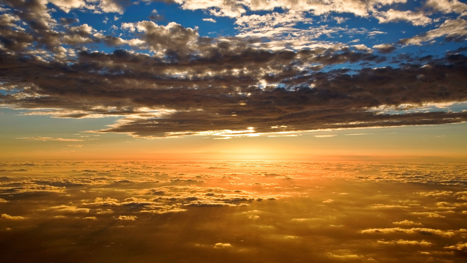 Sunset over clouds from airplane window HD Wallpaper