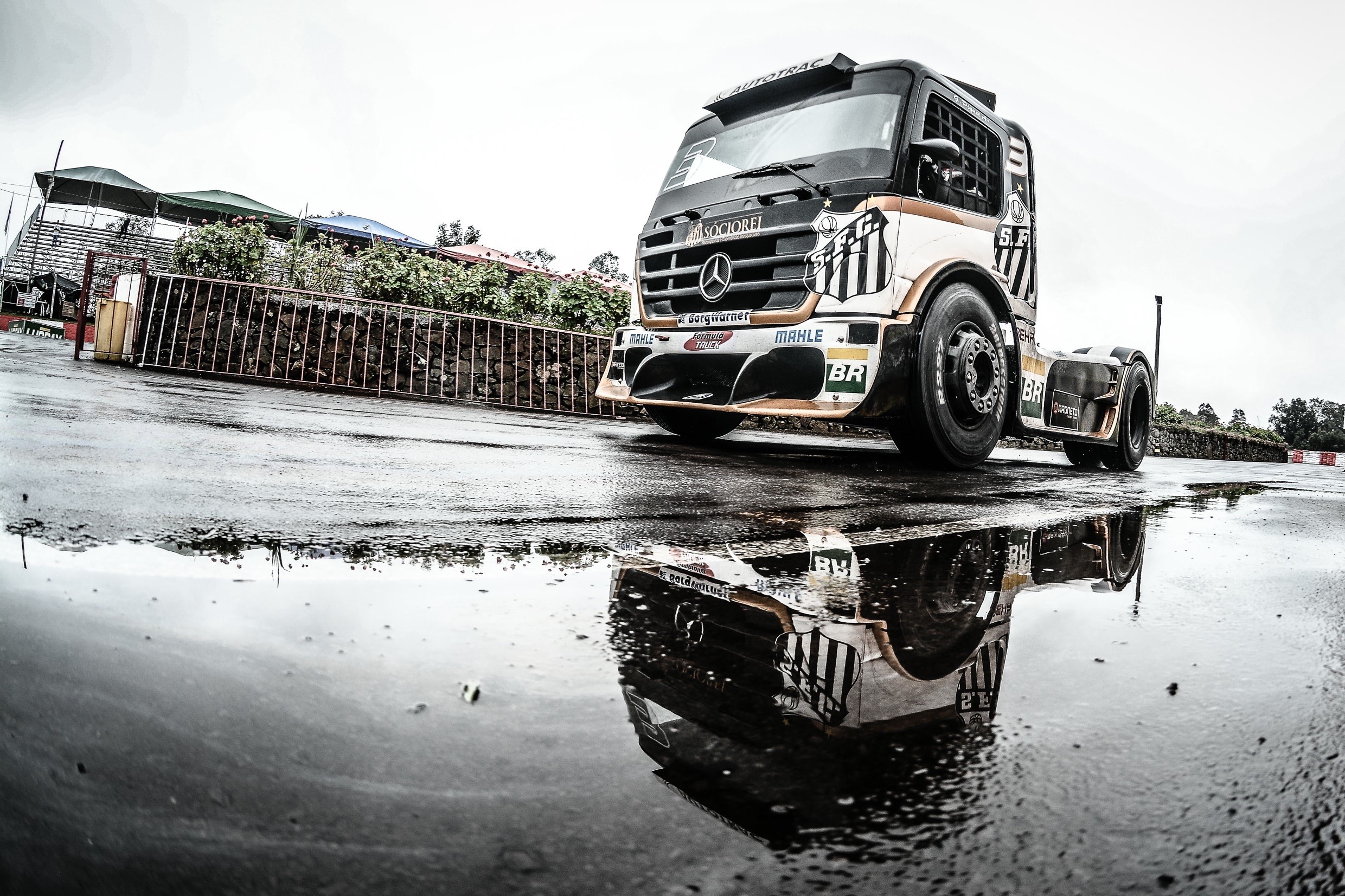 Mercedes-Benz Formula Truck reflection in puddle HD Wallpaper