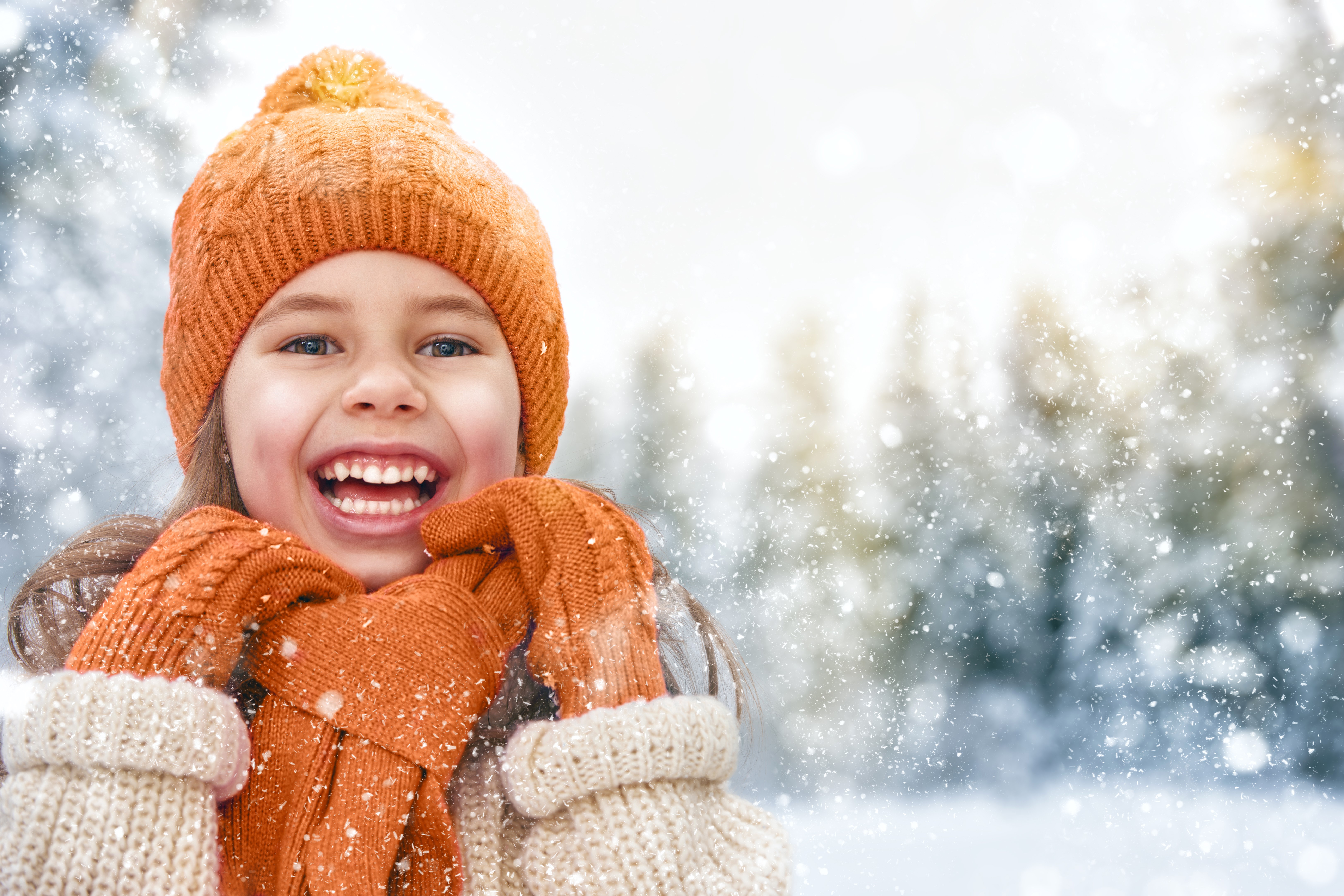 Little girl in winter hat and scarf laughing HD Wallpaper