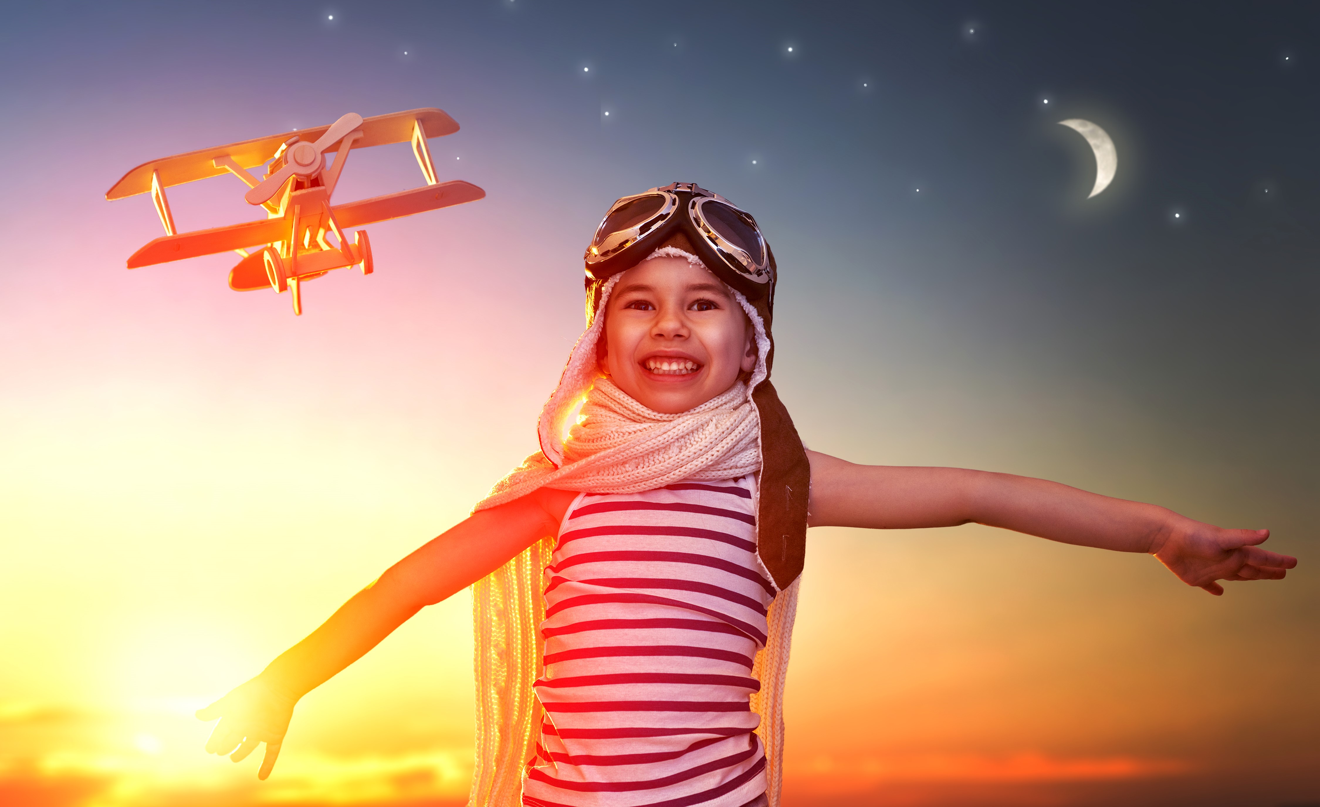 Girl in pilot costume with toy airplane at sunset HD Wallpaper