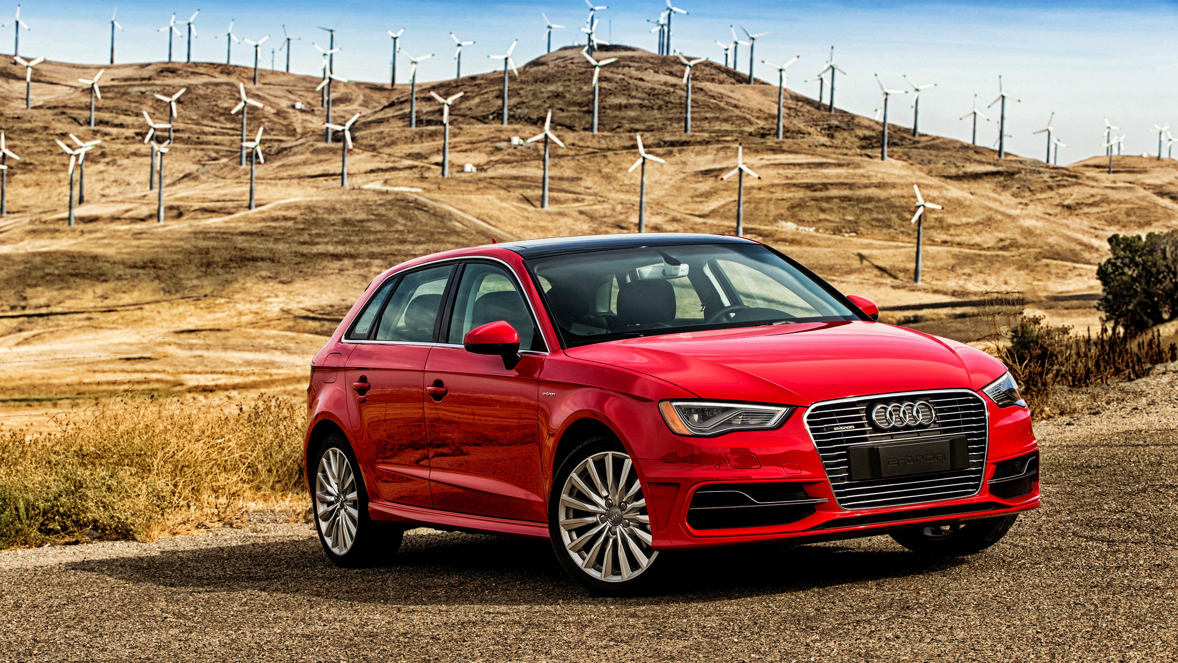 Red Audi A3 e-tron in front of wind turbines HD Wallpaper