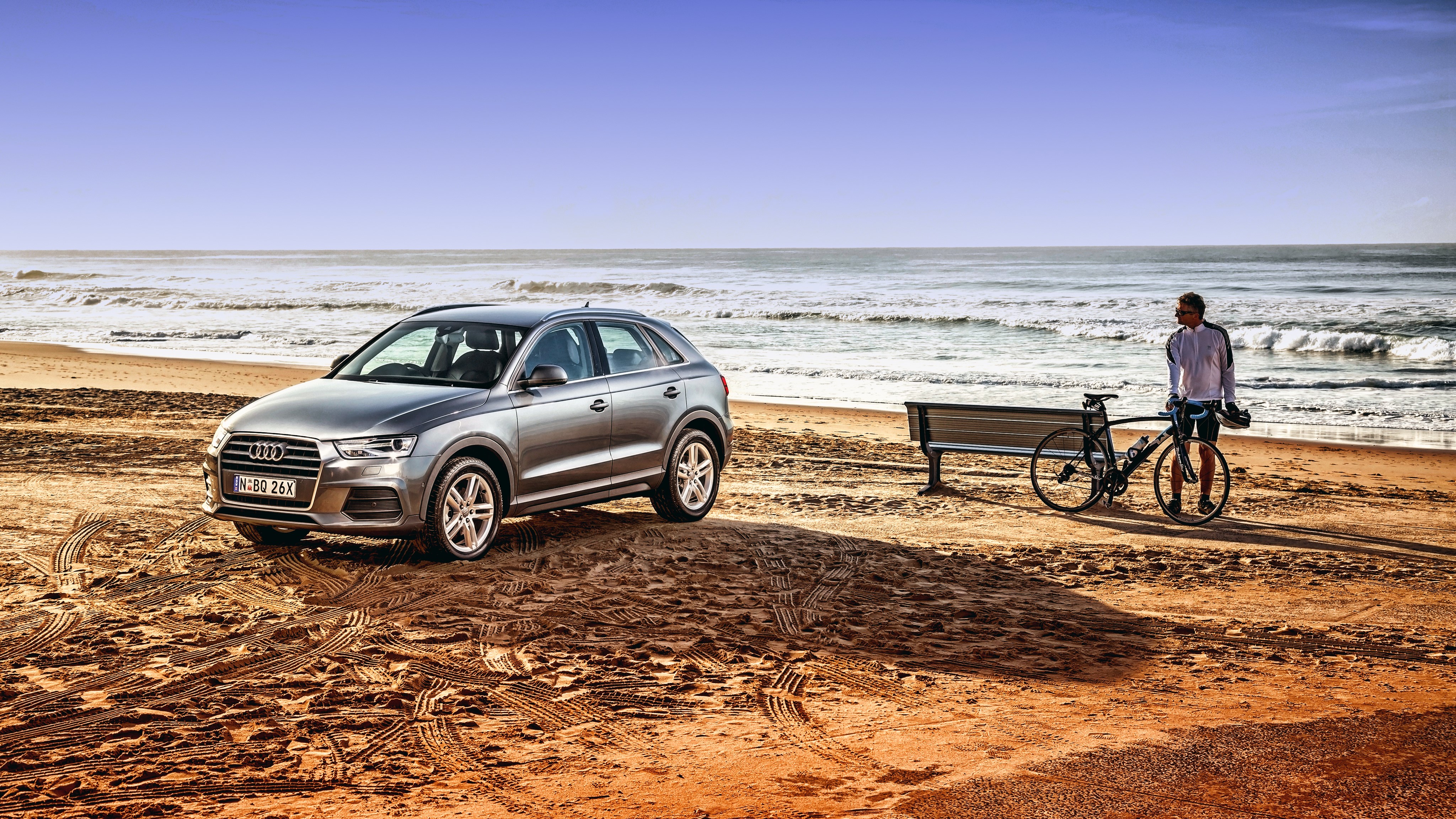 Audi car and cyclist on a beach HD Wallpaper
