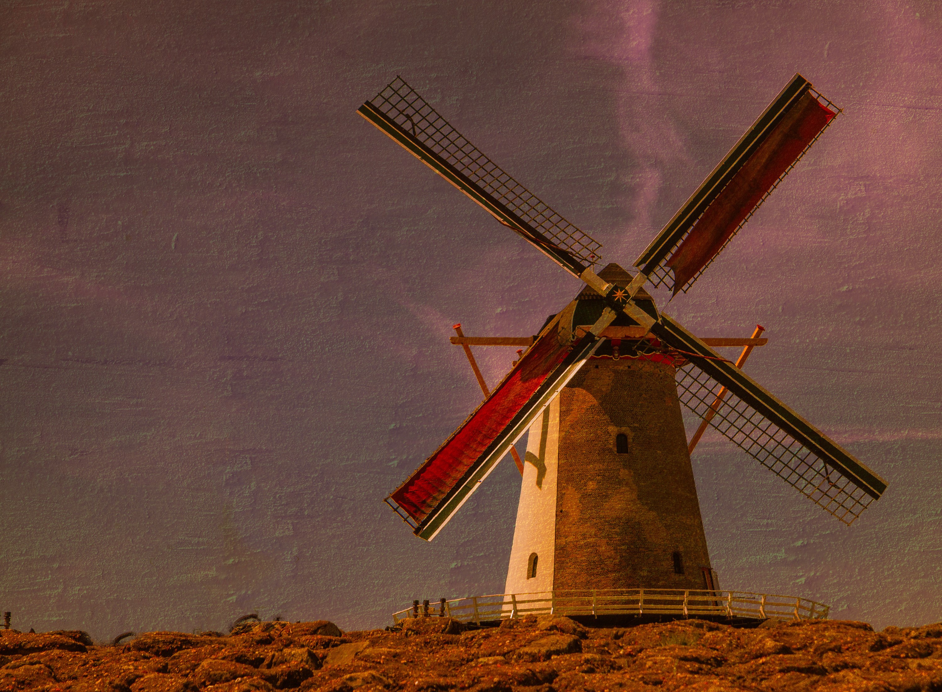 A Dutch windmill with red sails against a textured sky HD Wallpaper