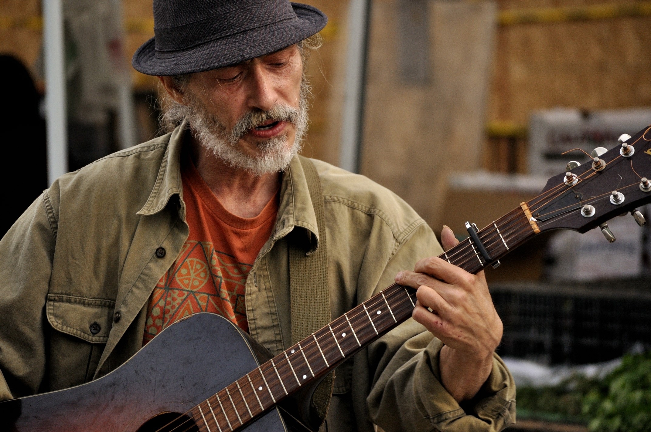 Man wearing a hat playing guitar HD Wallpaper