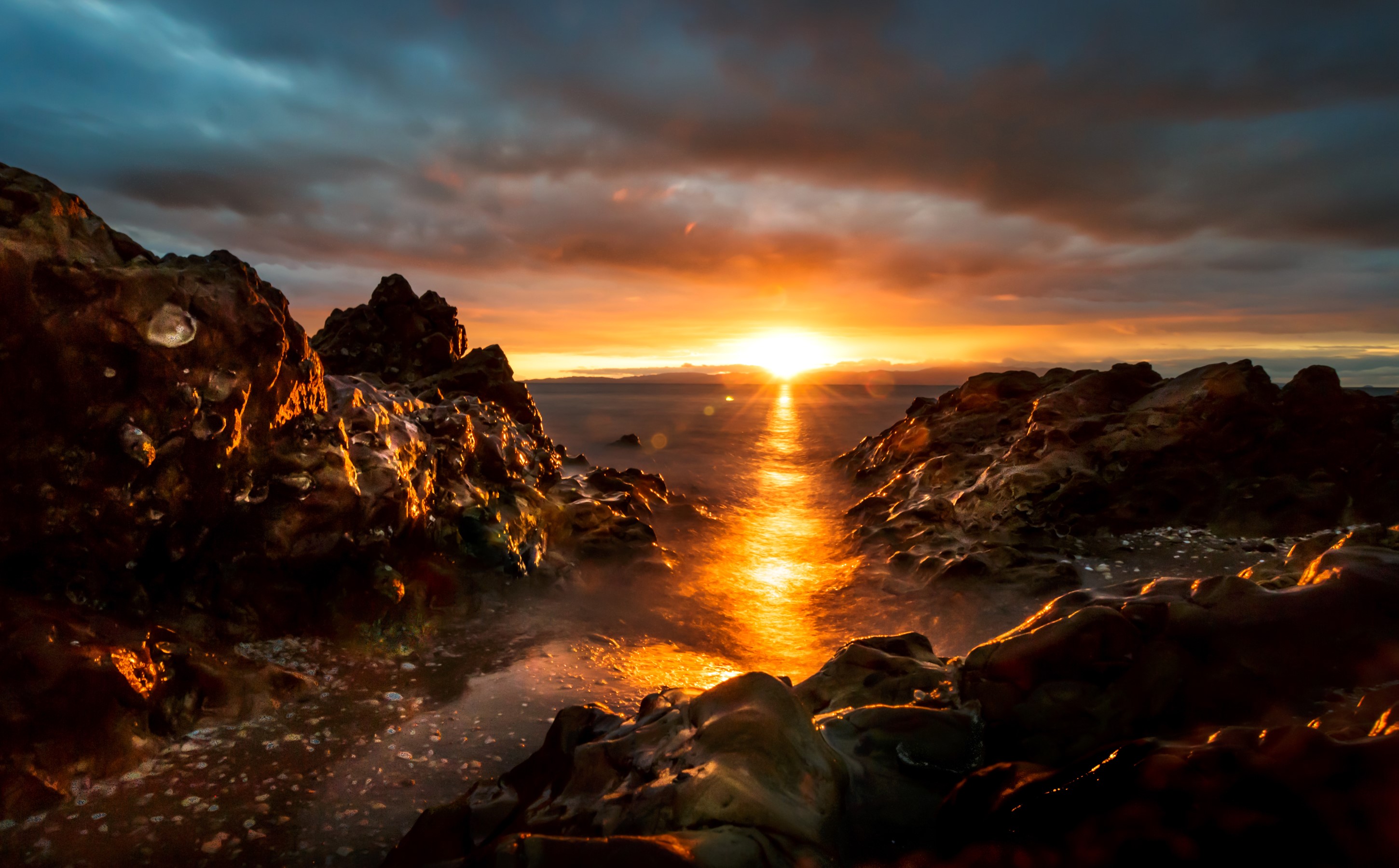 Sunset over the rocky coast with ocean waves HD Wallpaper