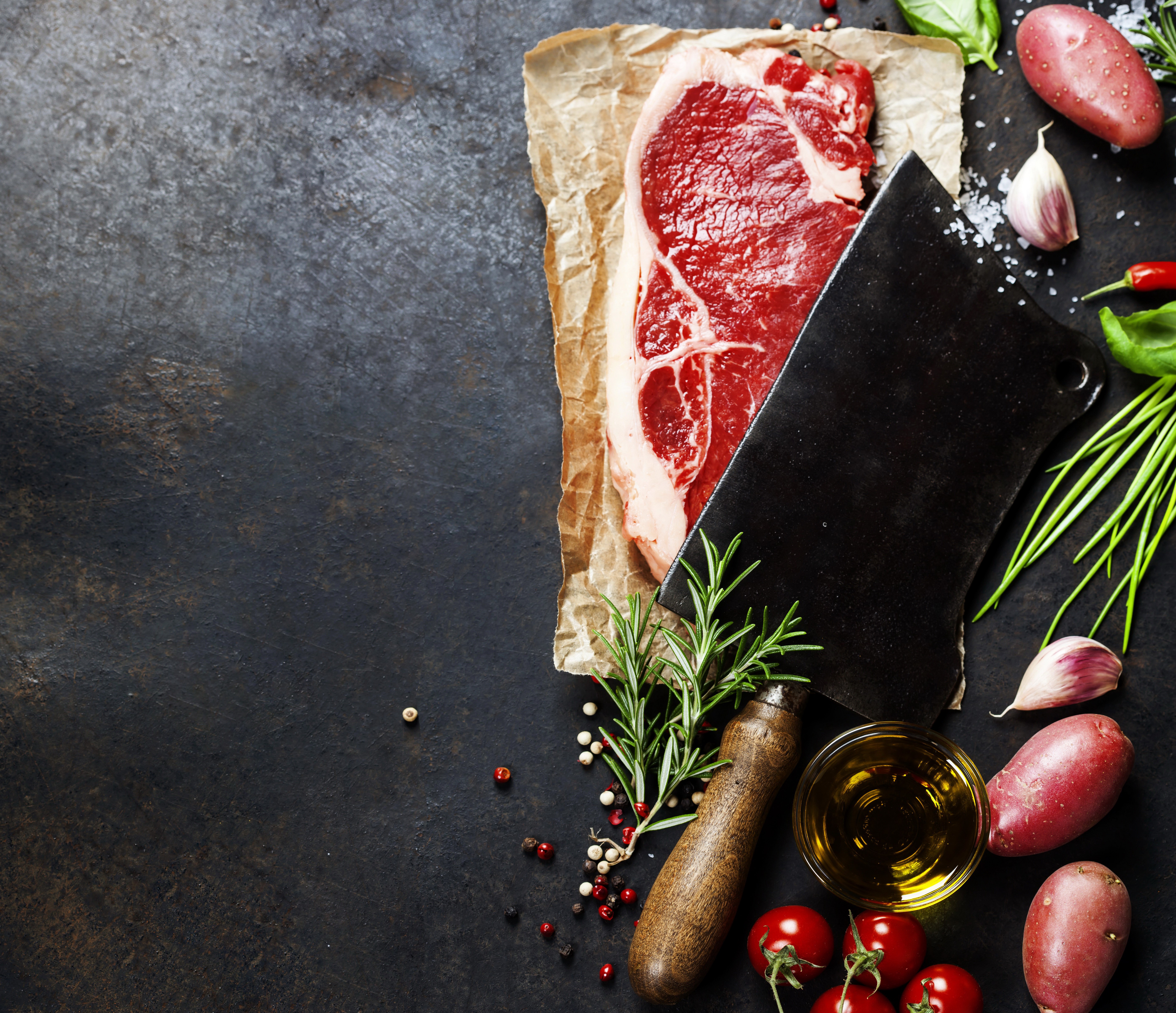 Raw steak with butcher knife and vegetables HD Wallpaper