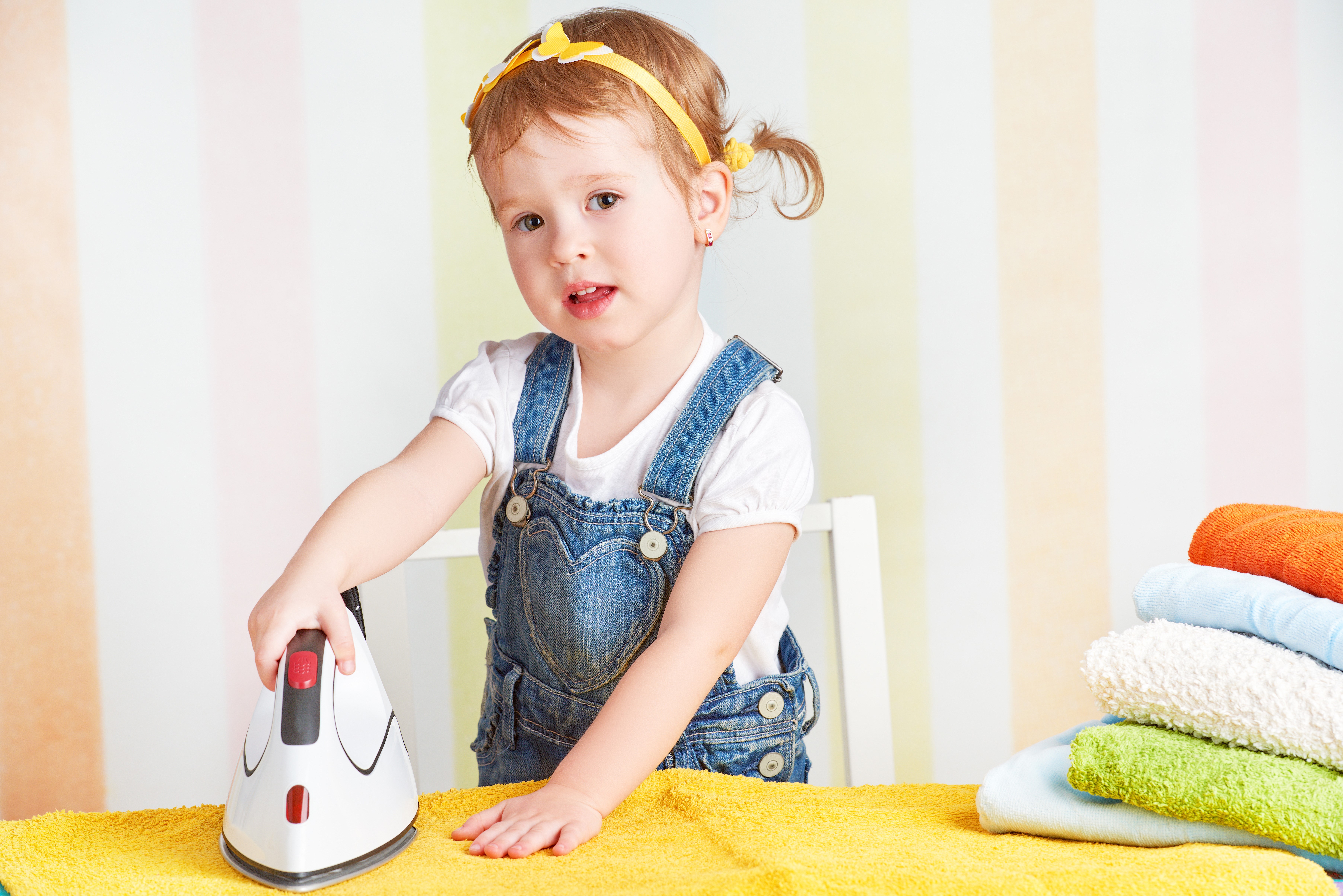 Little girl playing with an iron HD Wallpaper