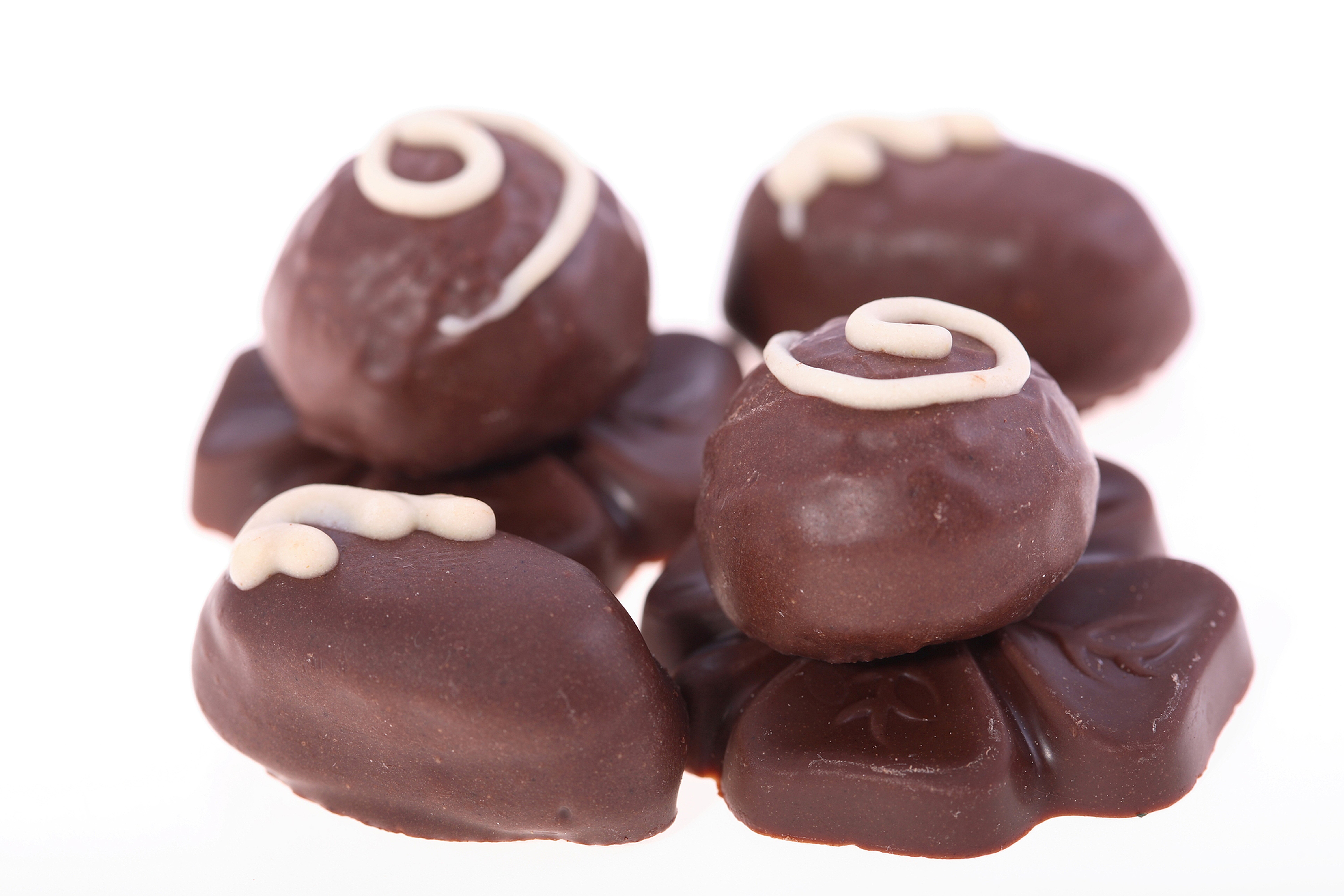 Assortment of chocolate candies with white icing HD Wallpaper