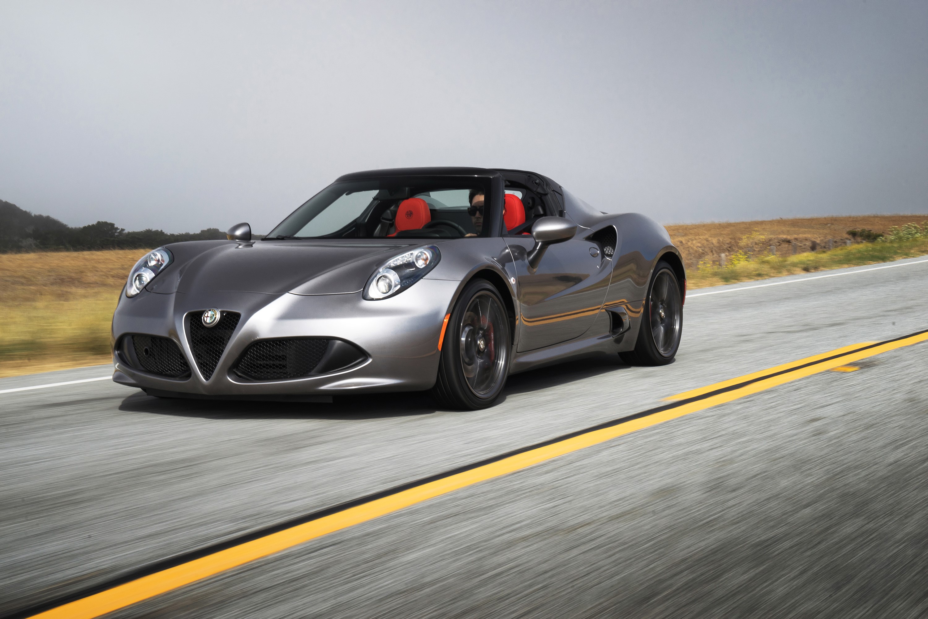 2016 Alfa Romeo 4C Spider driving on a road HD Wallpaper
