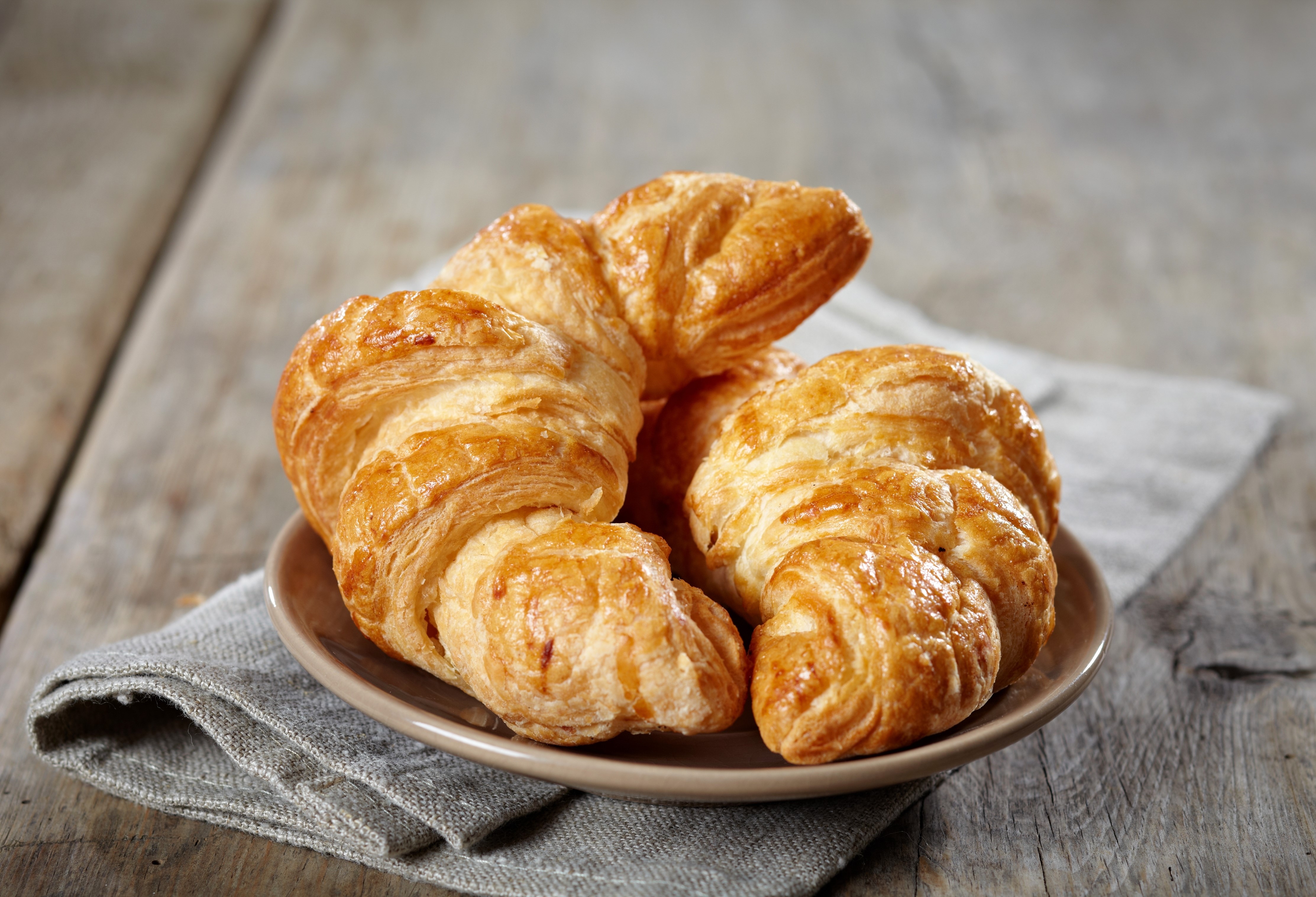 Croissants on a plate with a napkin HD Wallpaper