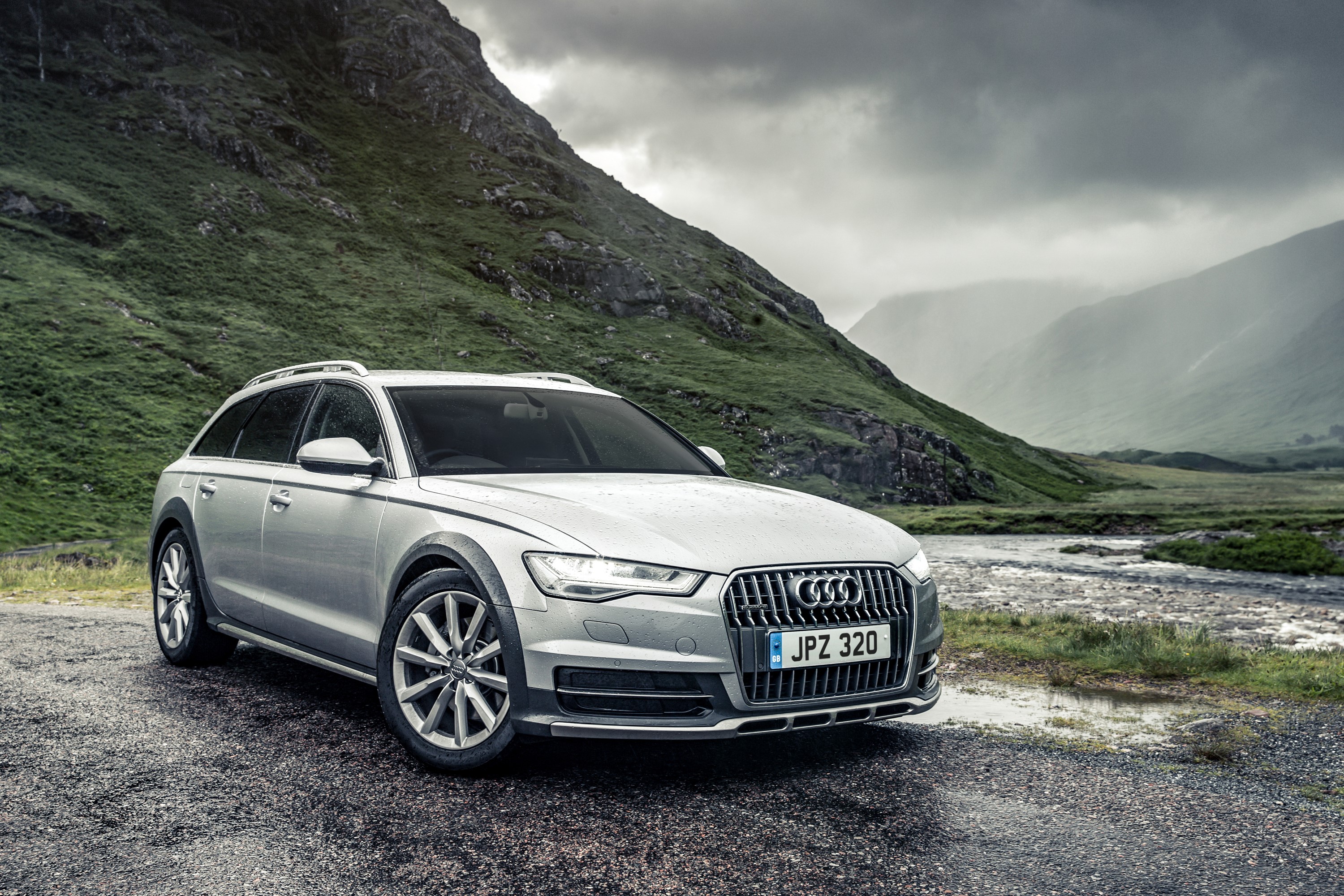 Silver Audi A6 Avant quattro estate car in a mountainous landscape HD Wallpaper