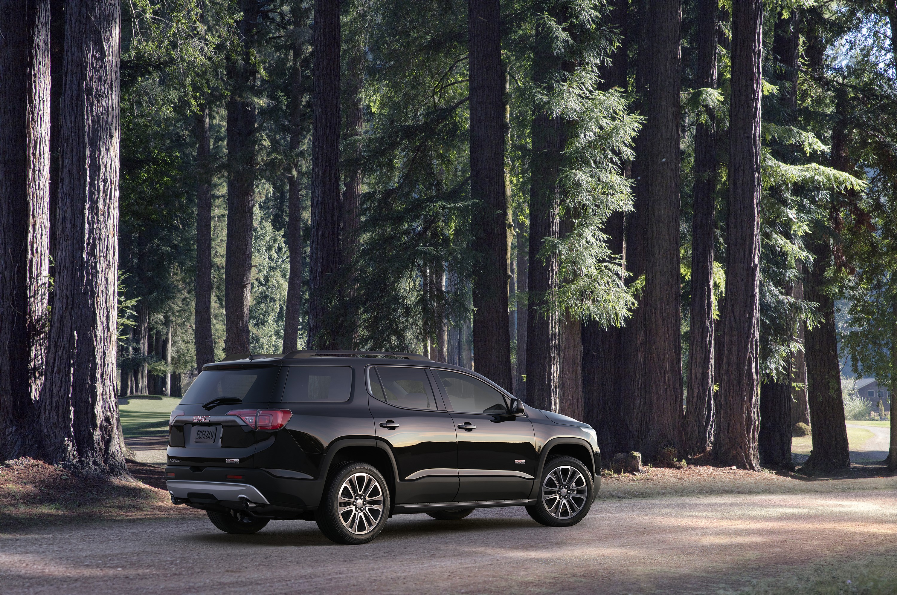Black GMC Acadia All Terrain in a Forest HD Wallpaper