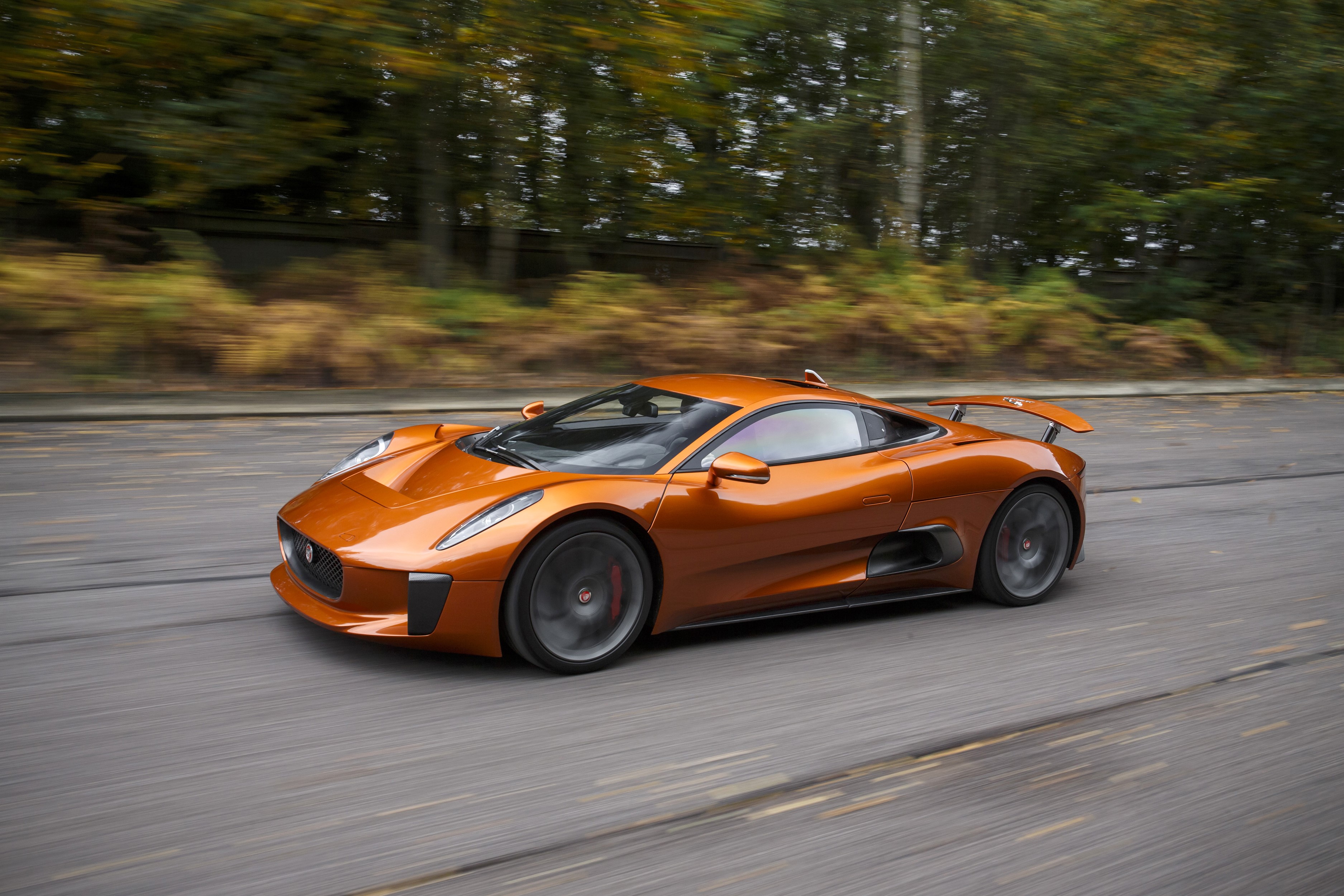 Orange Jaguar C-X75 Spectre concept car in motion HD Wallpaper