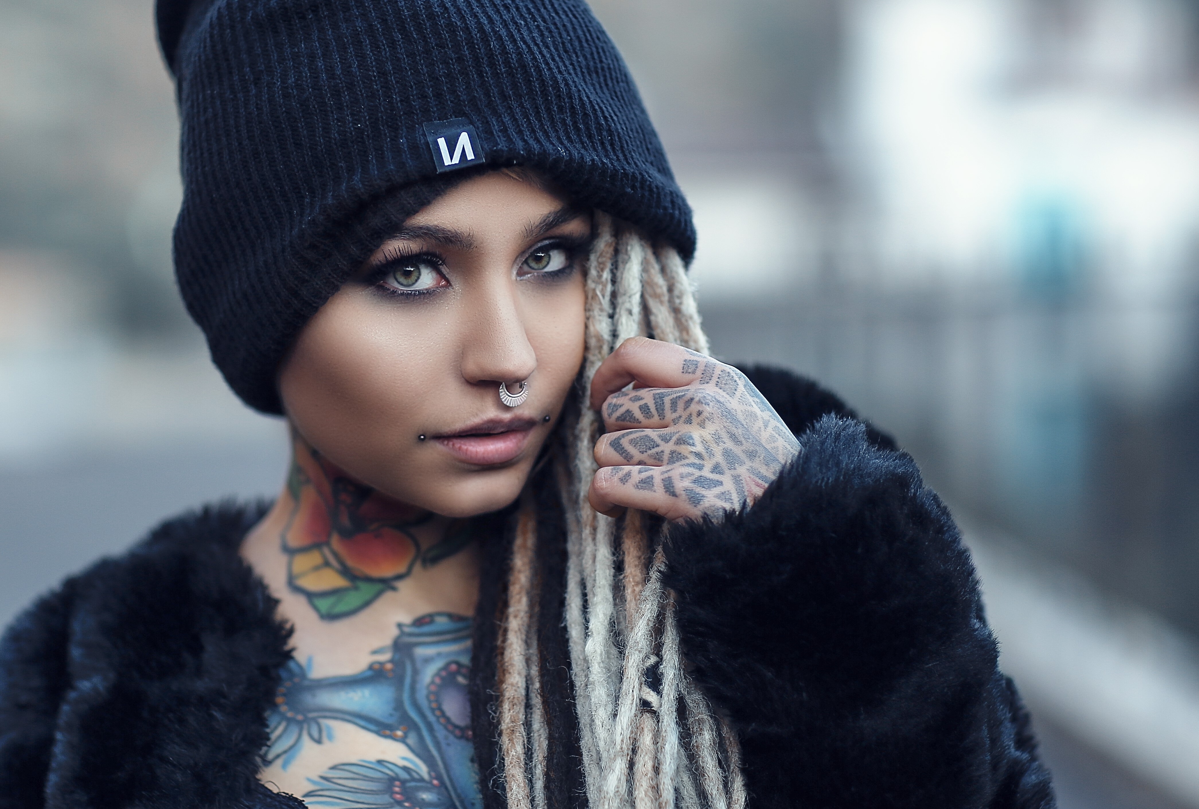 Woman with dreadlocks and tattoos wearing a winter hat HD Wallpaper