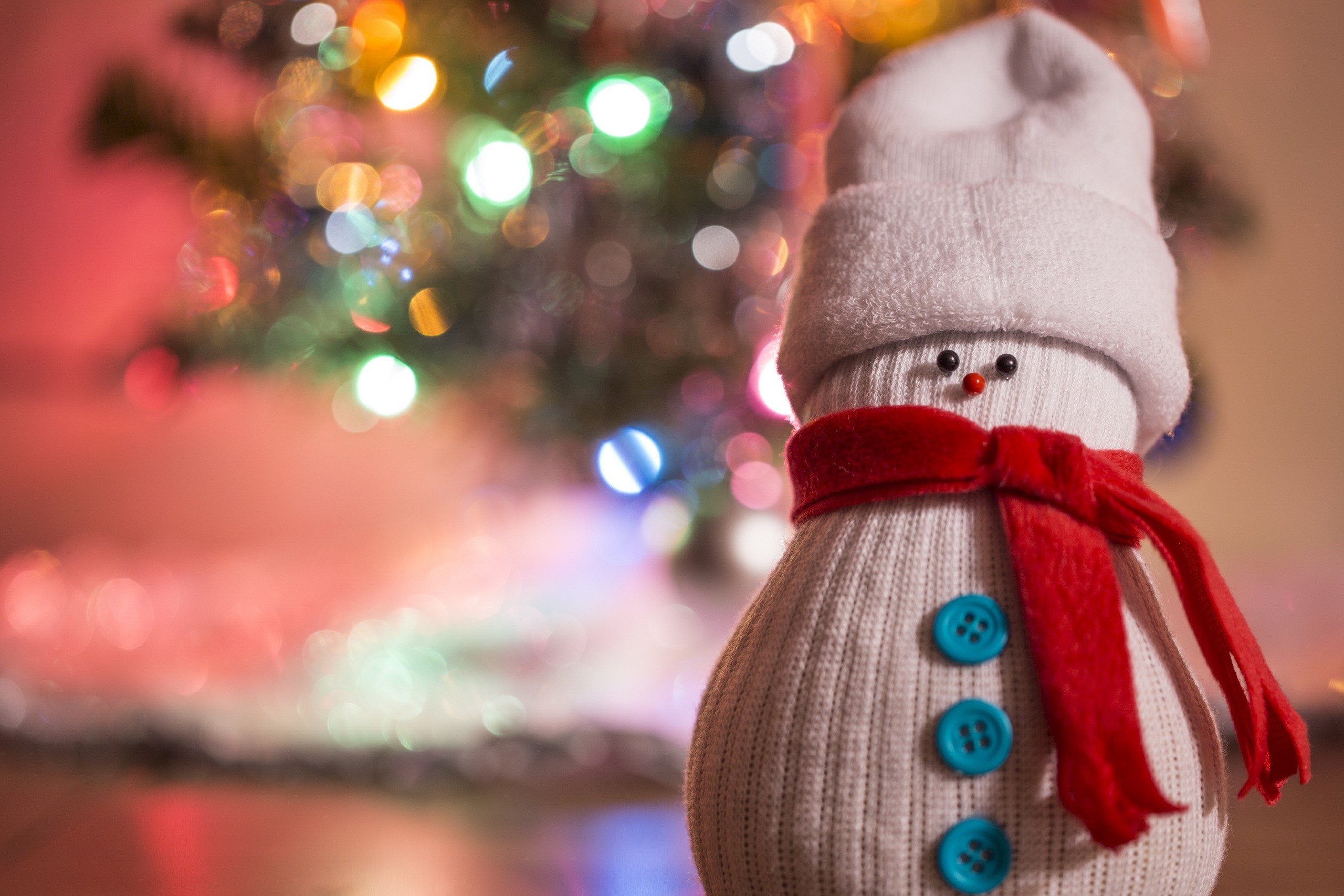 Sock snowman with red scarf and Christmas tree lights HD Wallpaper