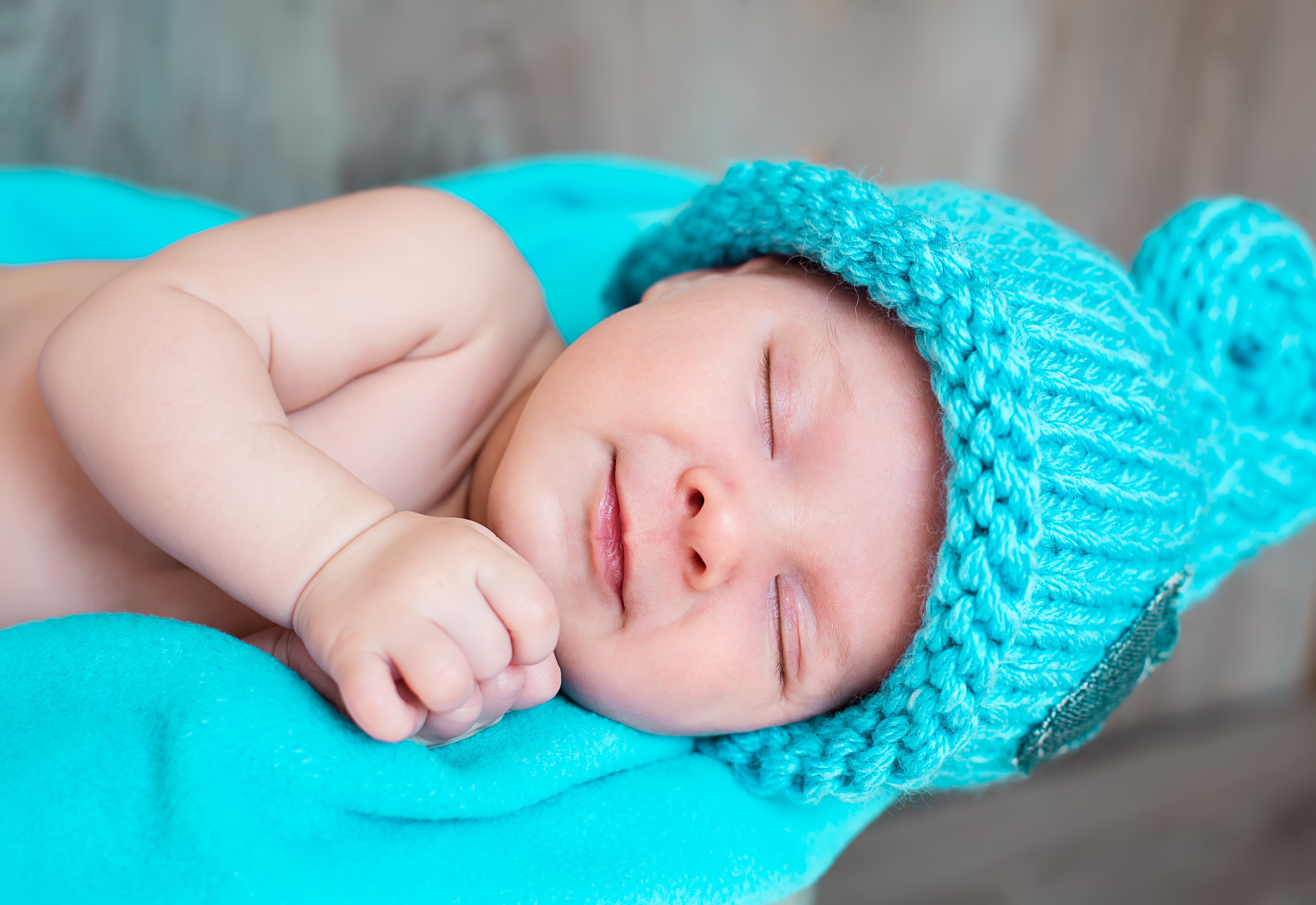 Baby sleeping in a blue winter hat HD Wallpaper