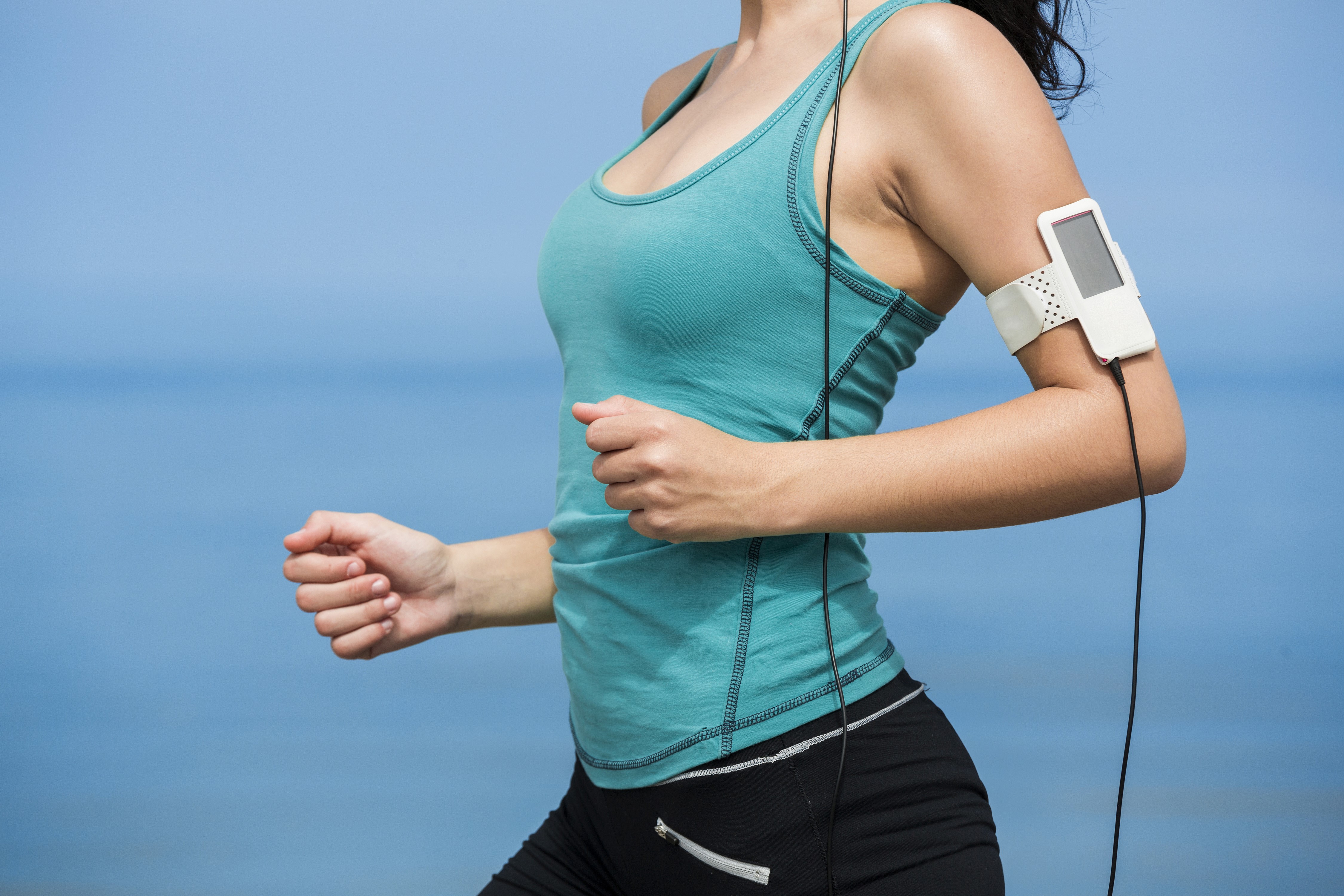 Woman running with armband music player HD Wallpaper