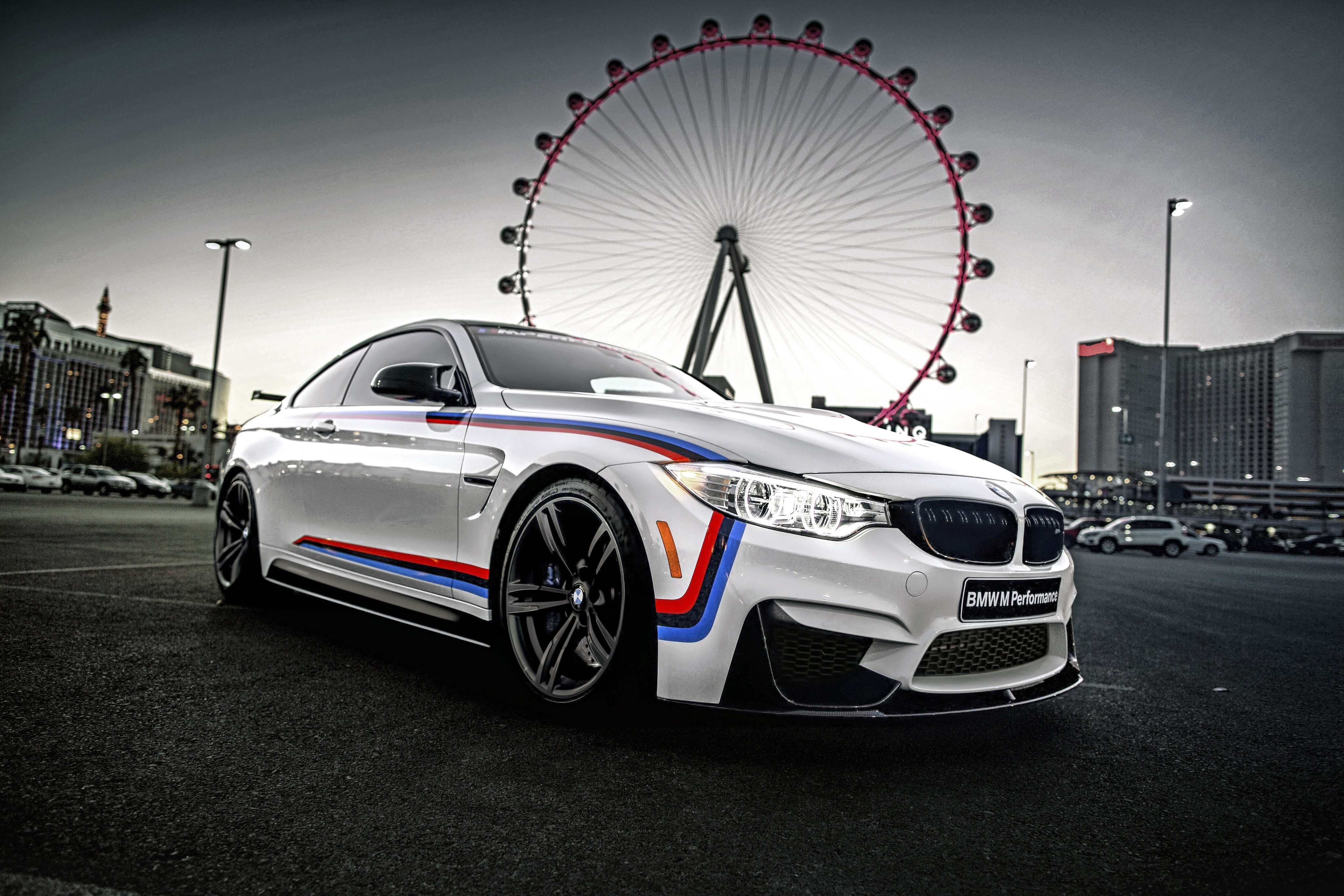 White BMW M4 Coupe with BMW M Performance decals and Ferris wheel HD Wallpaper