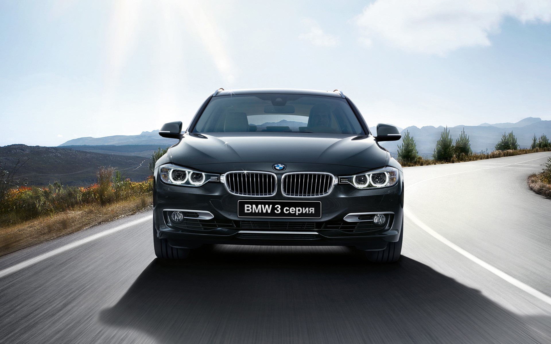 BMW 3 Series Touring car on a road HD Wallpaper