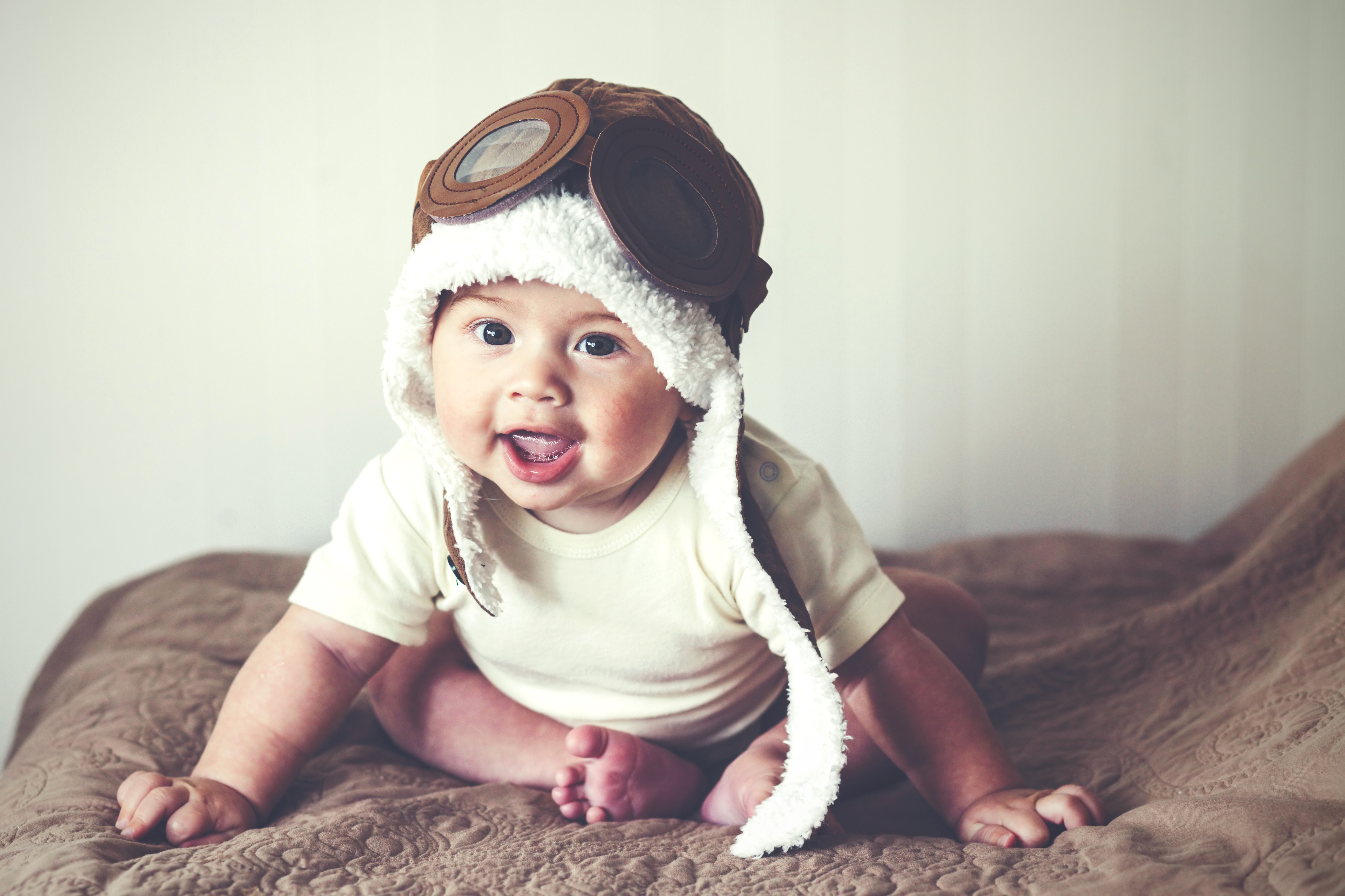 Baby wearing a pilot hat HD Wallpaper
