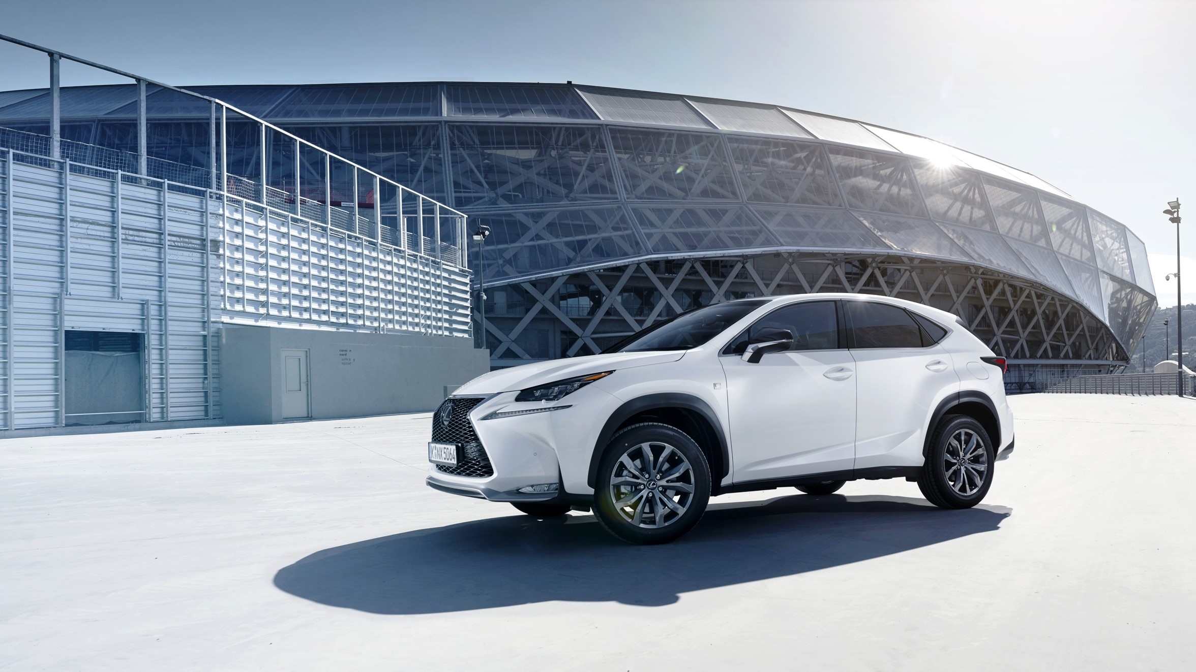 White Lexus NX 200 F-Sport EU-spec parked near stadium HD Wallpaper
