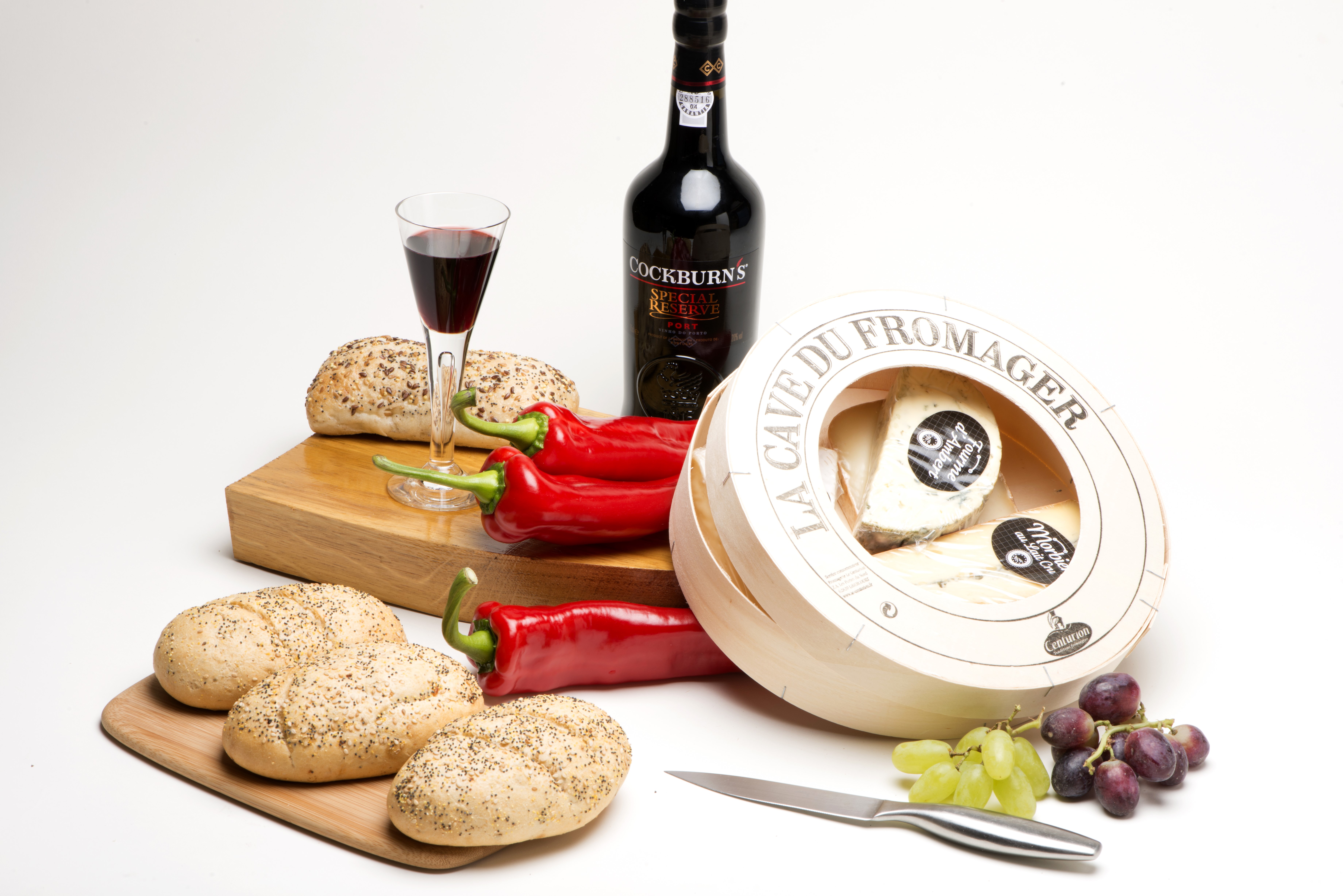 Still-life of wine, cheese, bread, peppers, and grapes HD Wallpaper