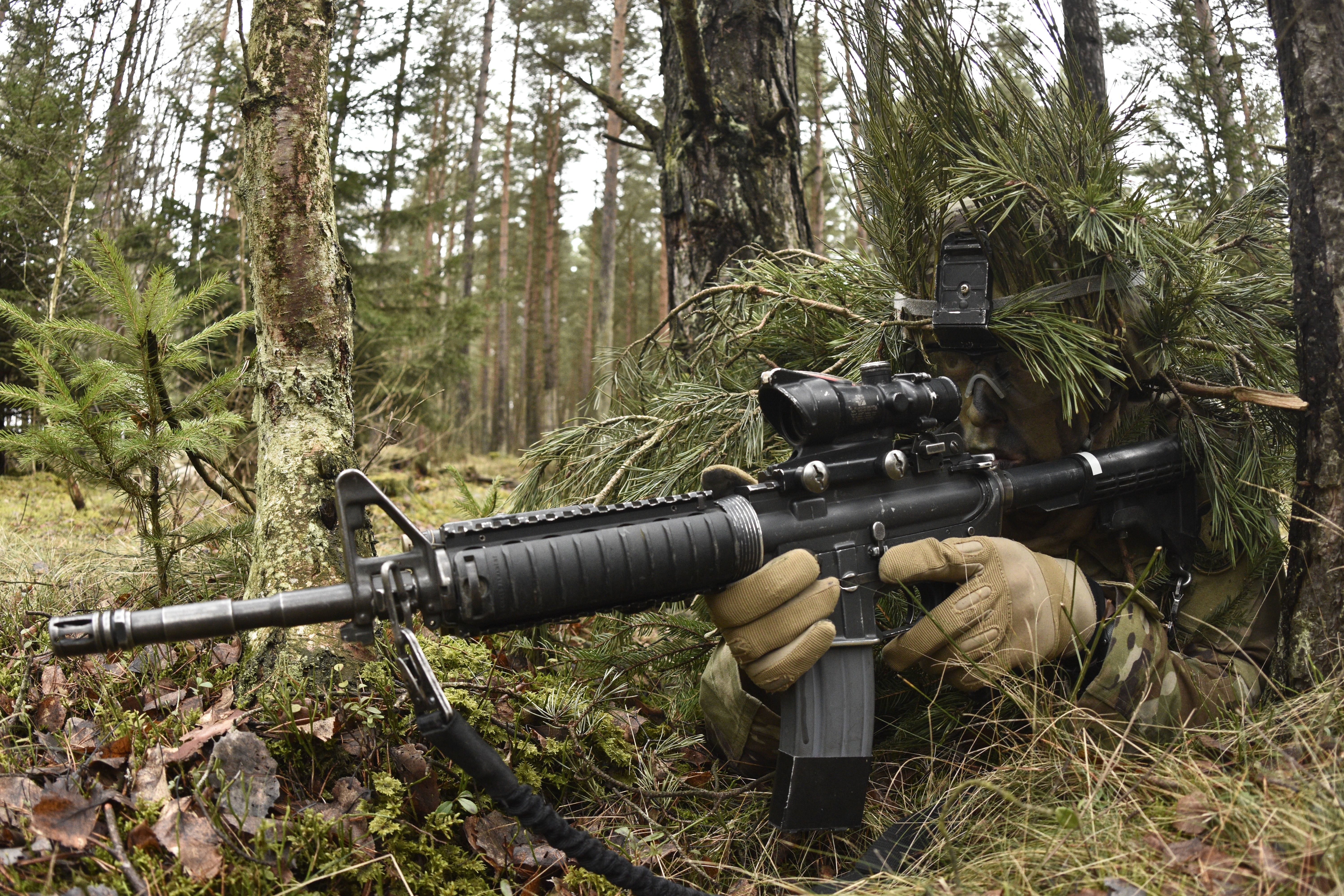 Soldier with rifle in forest HD Wallpaper