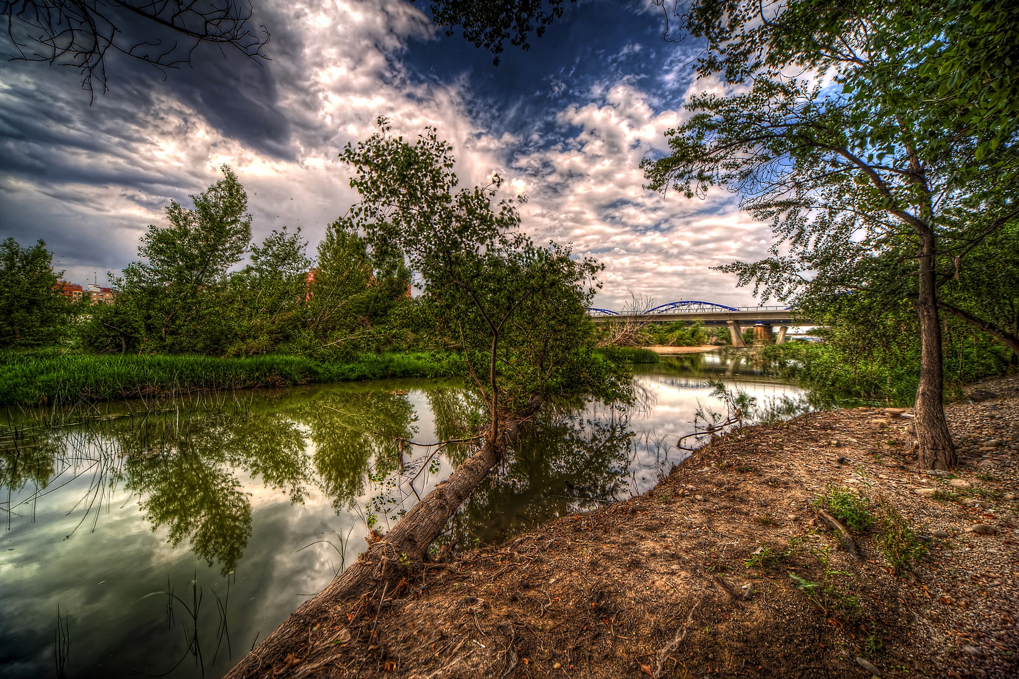 River with bridge and trees under cloudy sky HD Wallpaper