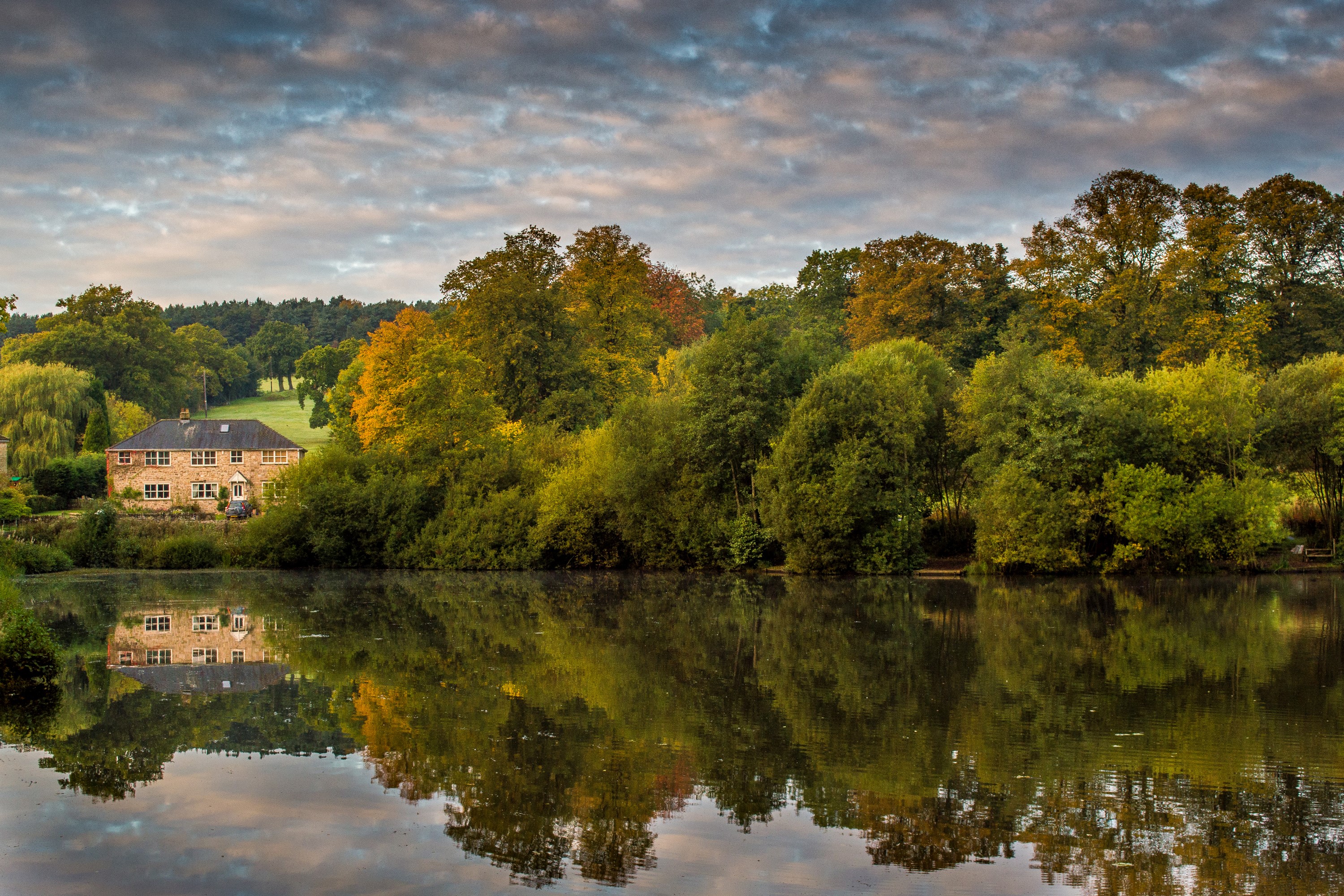 House by a lake with autumn trees HD Wallpaper