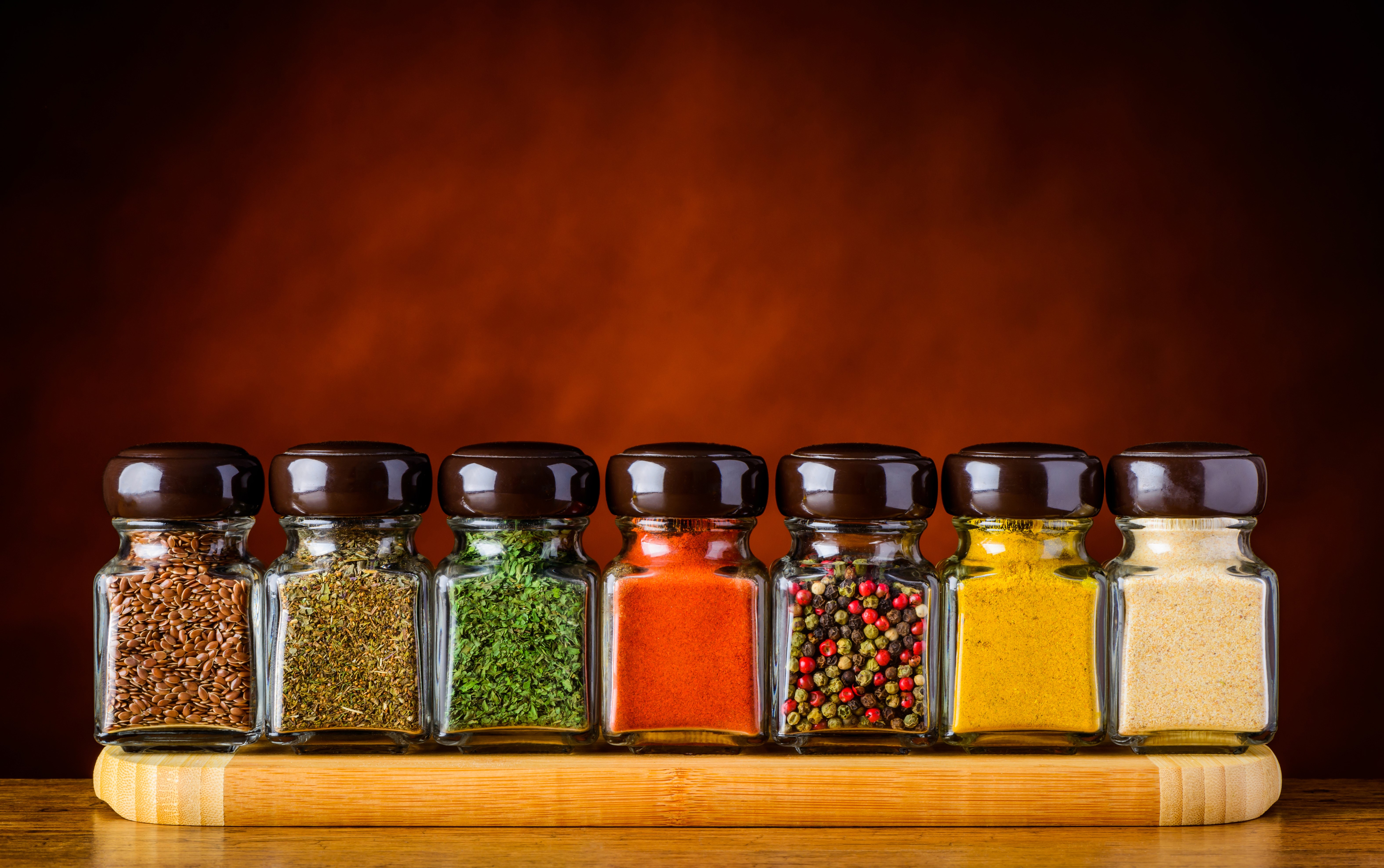 Jars of spices on a wooden board HD Wallpaper